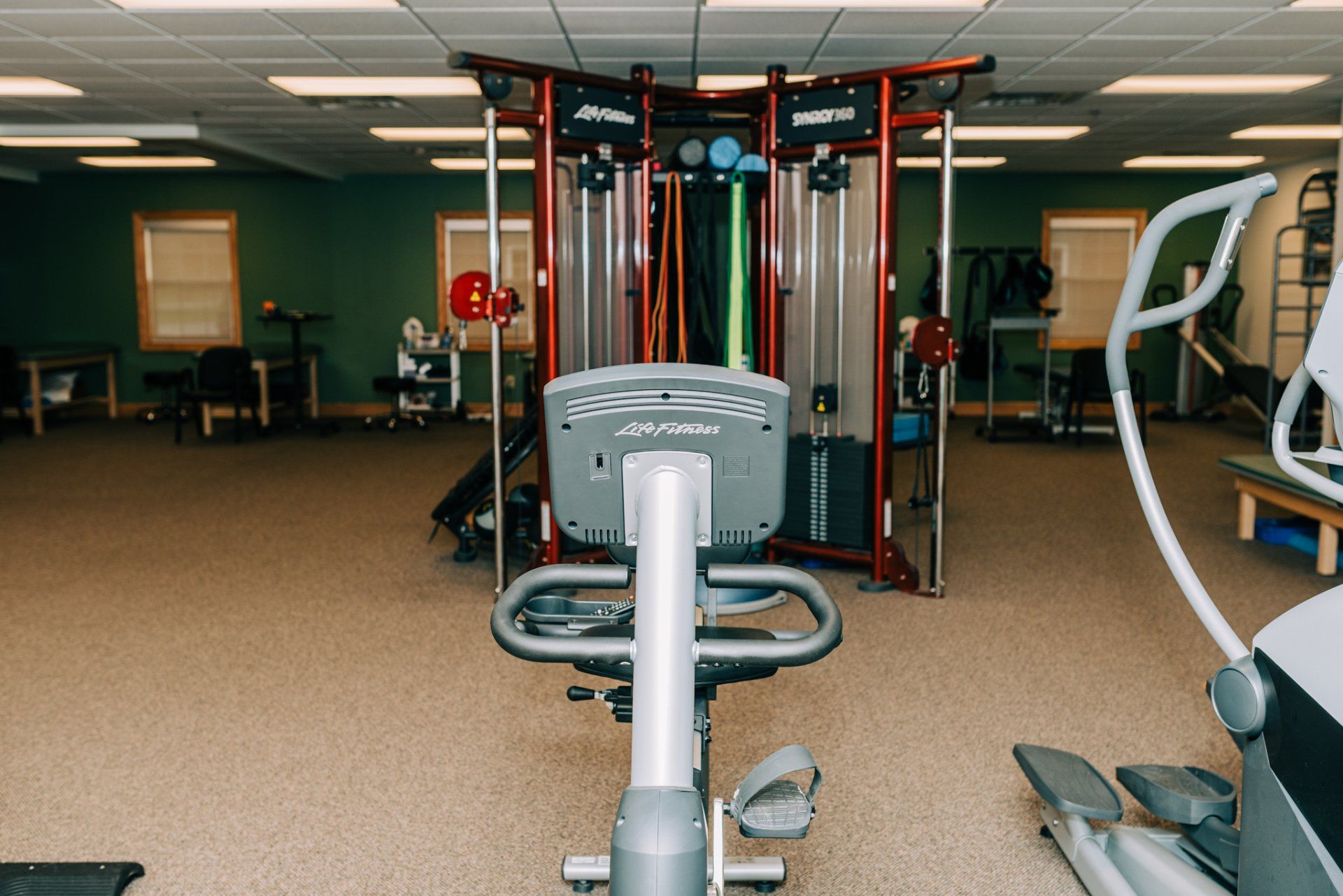 There is a bicycle in the middle of a gym.