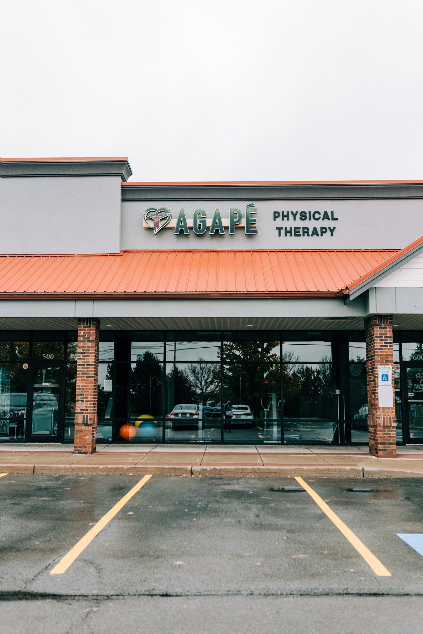 A physical therapy clinic with a parking lot in front of it.