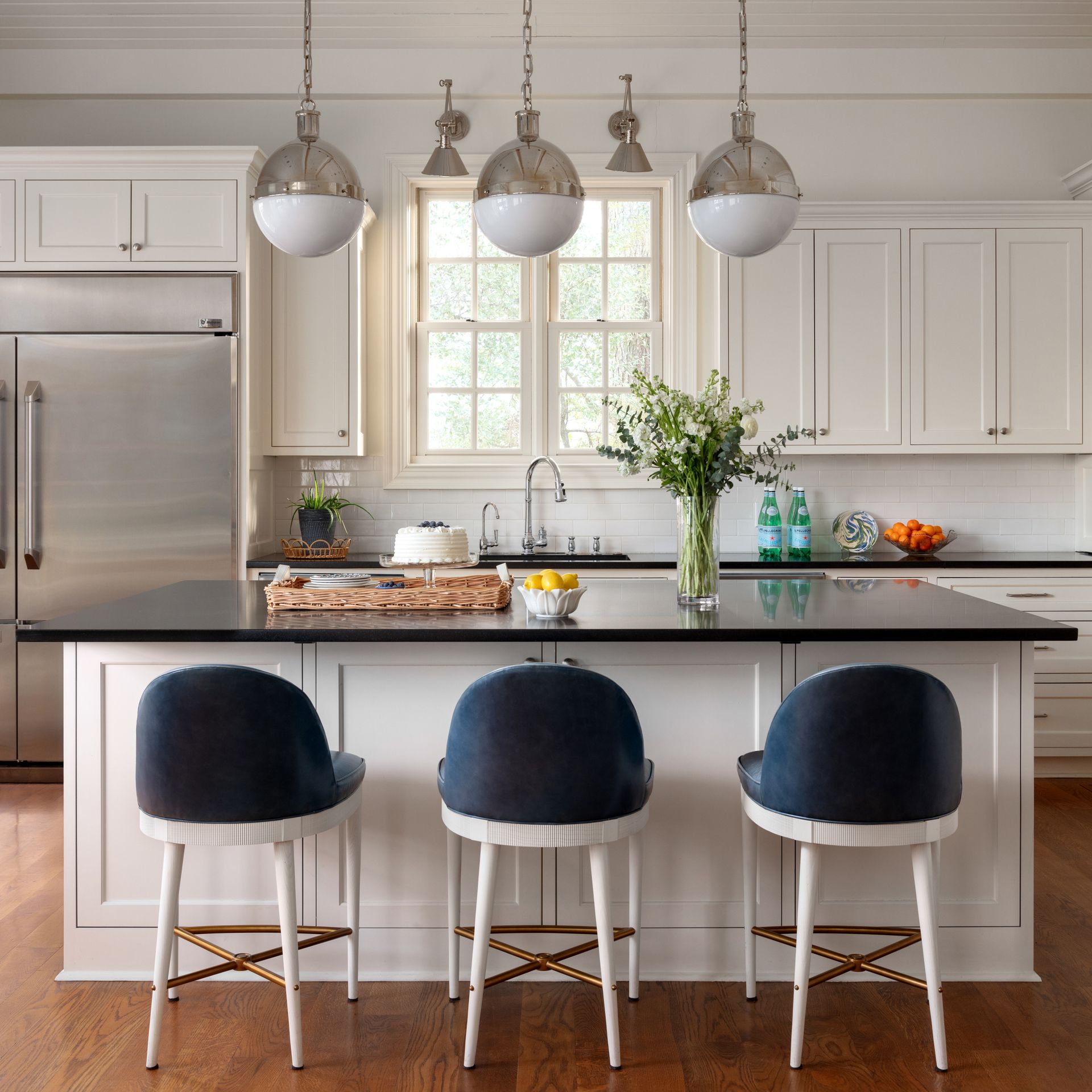 A gorgeous kitchen featuring silver hanging lights