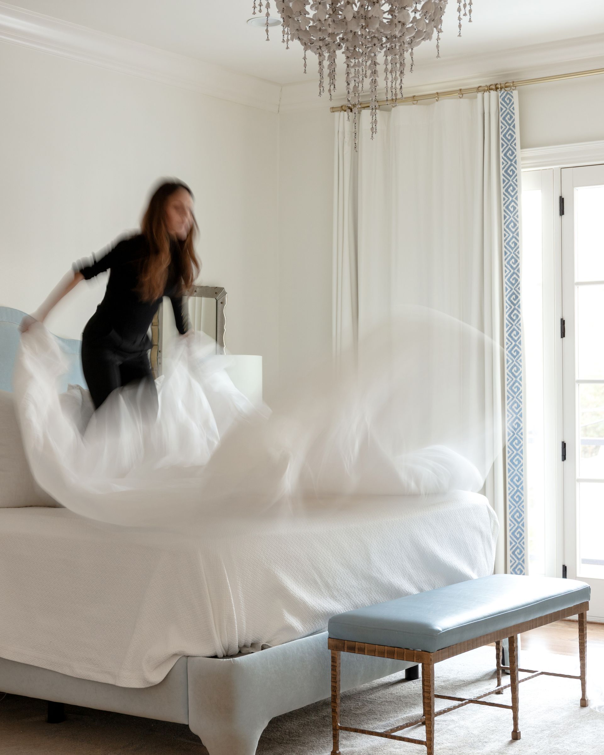 Carrie Kidd decorating a bed