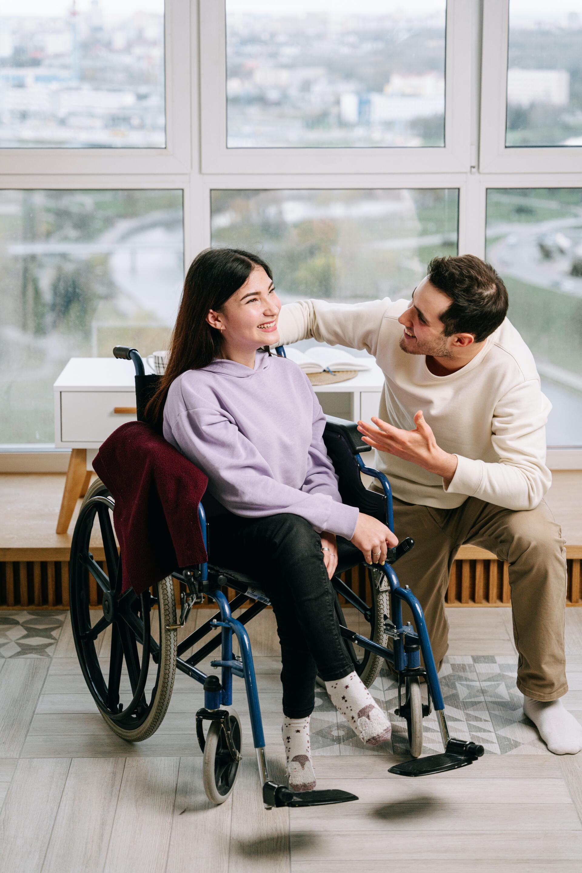 Man talking to woman in wheelchair