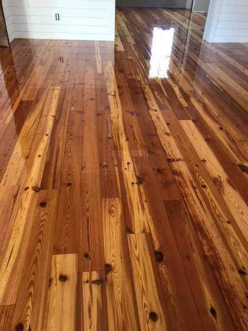 A room with a wooden floor and a white wall.