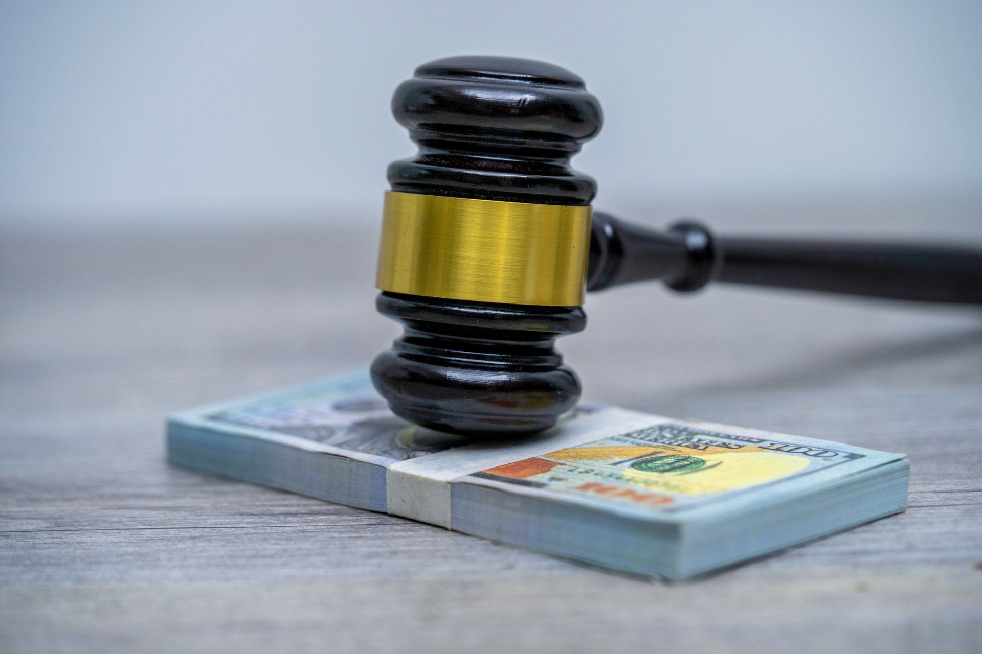 Gavel on Top of a Pile of Cash — Morganton, NC — Willcox Law Firm PLLC