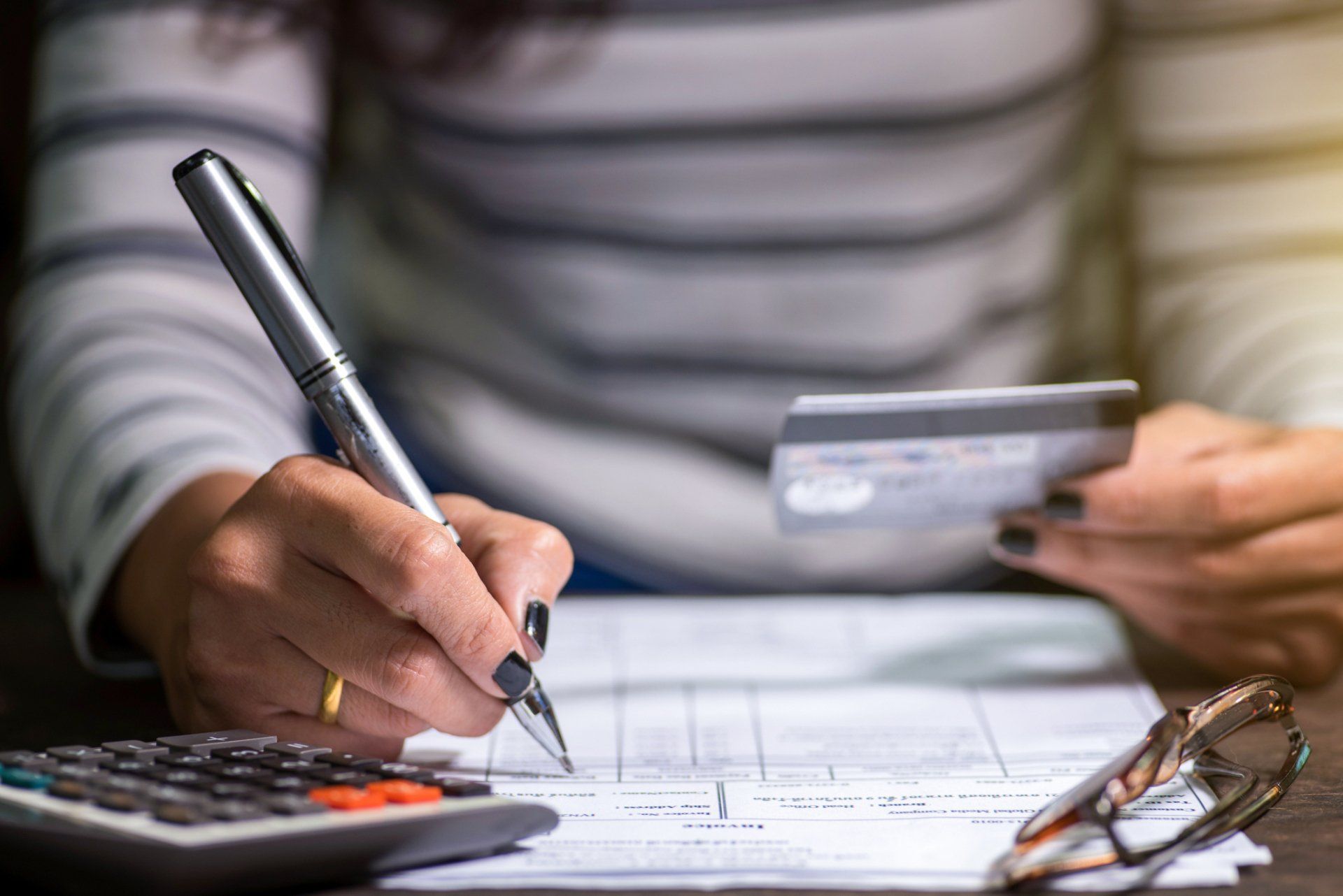 Person Writing on a Piece of Paper — Morganton, NC — Willcox Law Firm PLLC Person Writing on a Piece of Paper — Morganton, NC — Willcox Law Firm PLLC