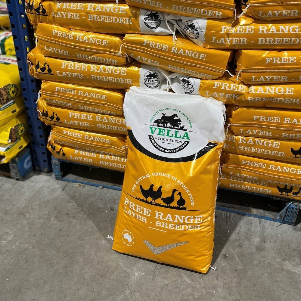 Yellow Vella Layer-breeder Feed Bag With Chickens on Blue Shelf — Gloucester Rural Supplies in Bulahdelah, NSW