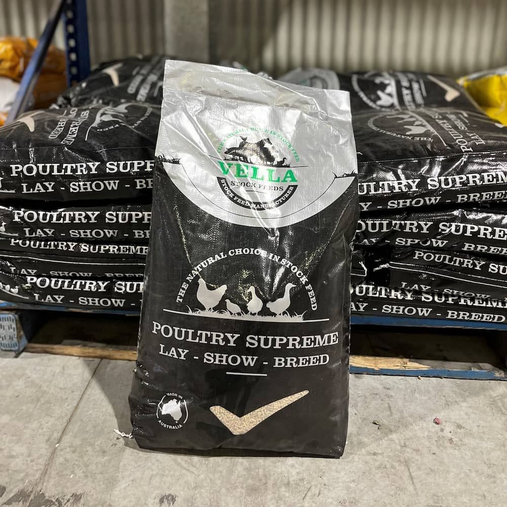 Black Valla Poultry Supreme Feed Bag in Front of Stacked Pallet — Gloucester Rural Supplies in Stroud, NSW