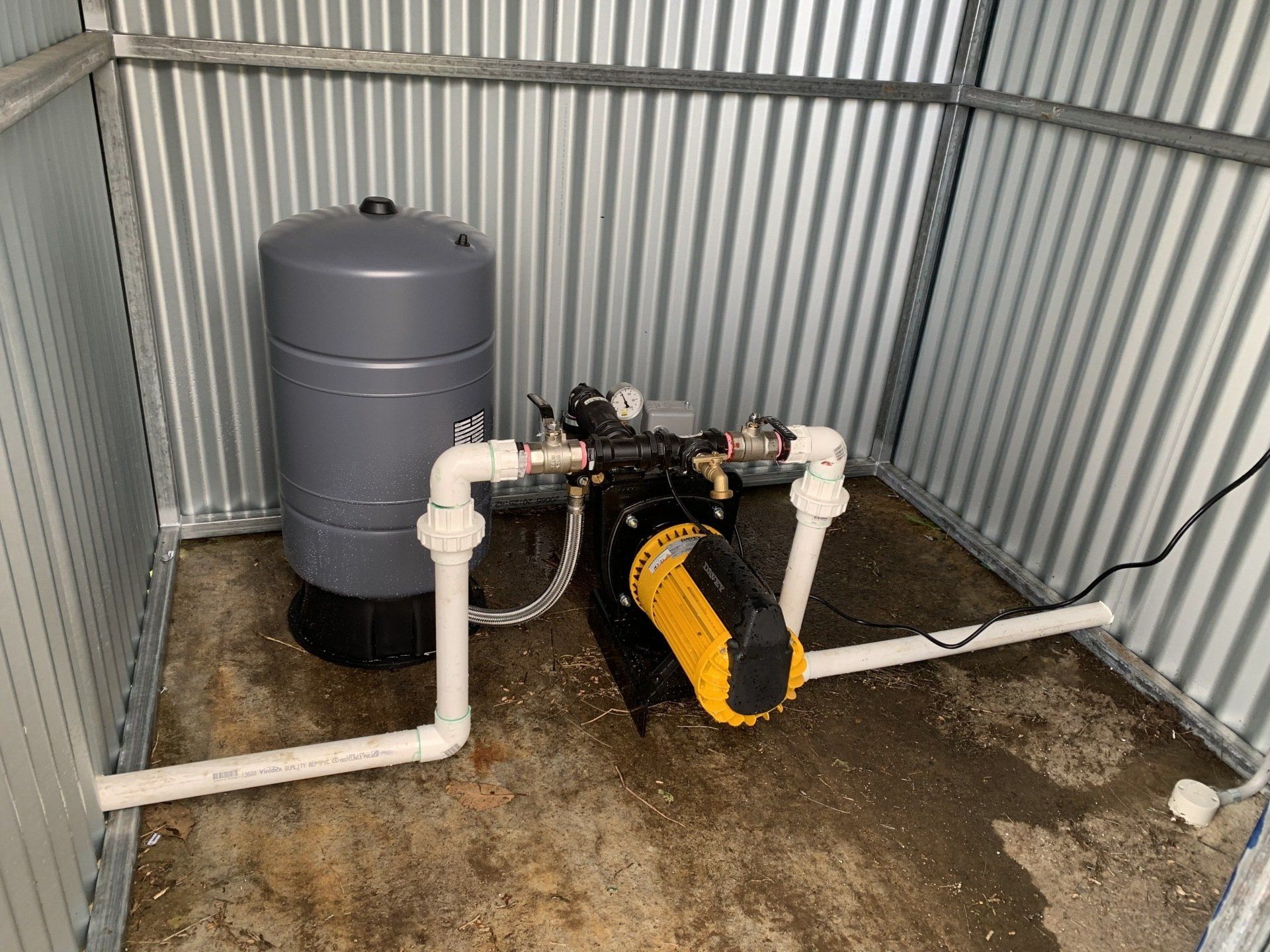 A Water Pump is Sitting Inside of a Metal Shed — Gloucester Rural Supplies in Gloucester, NSW