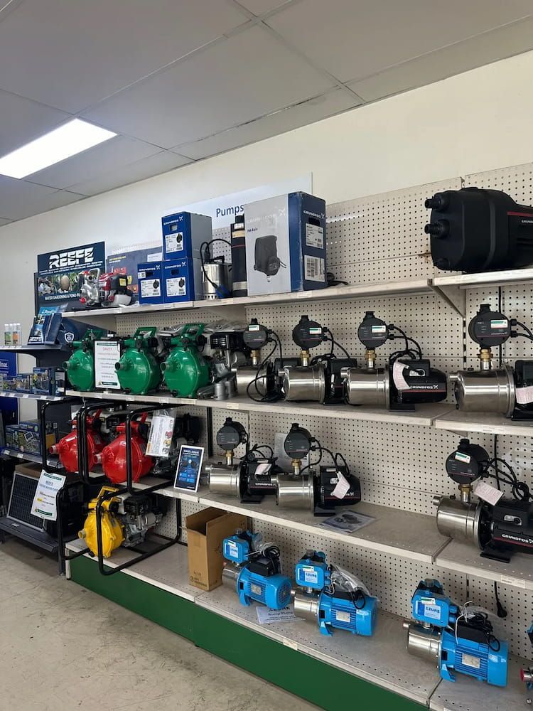 Shelves Stocked With Green, Red, Black, and Blue Water Pumps in Store — Gloucester Rural Supplies in Bulahdelah, NSW