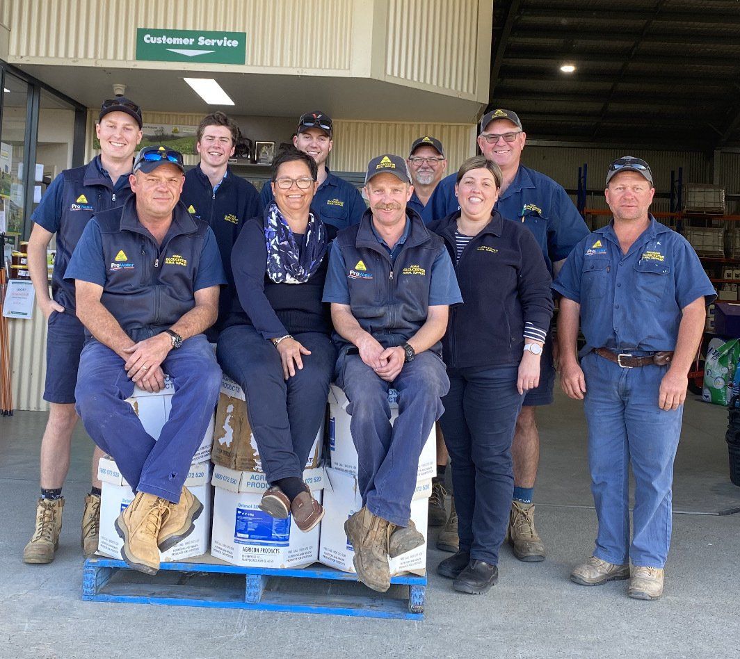 A Group of People Posing for a Picture in Front of a Building — Gloucester Rural Supplies in Gloucester, NSW