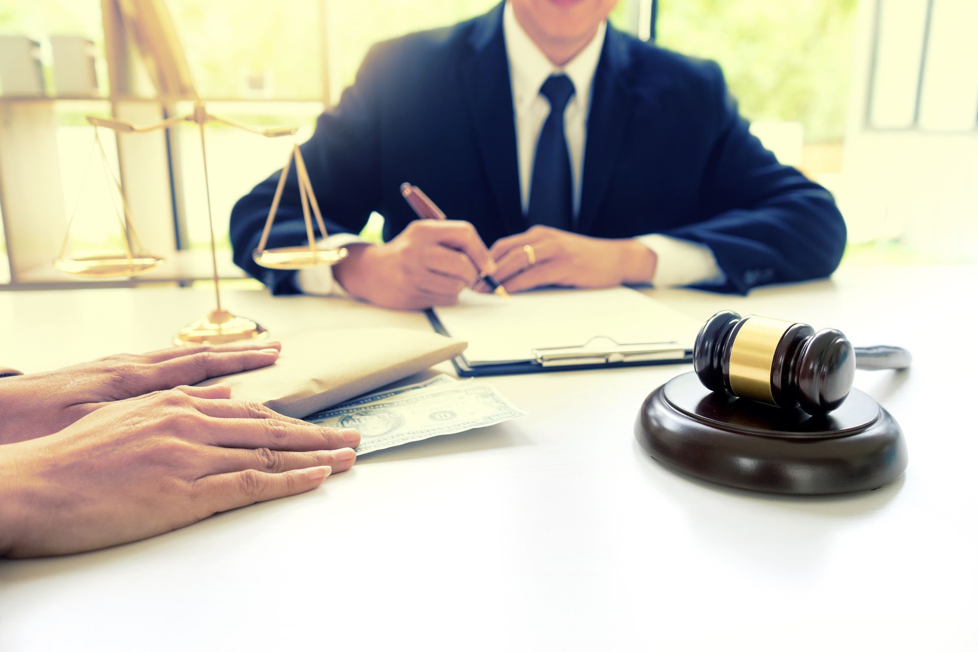 Criminal defense lawyer meeting with a client to review case documents. Criminal defense lawyer meeting with a client to review case documents.