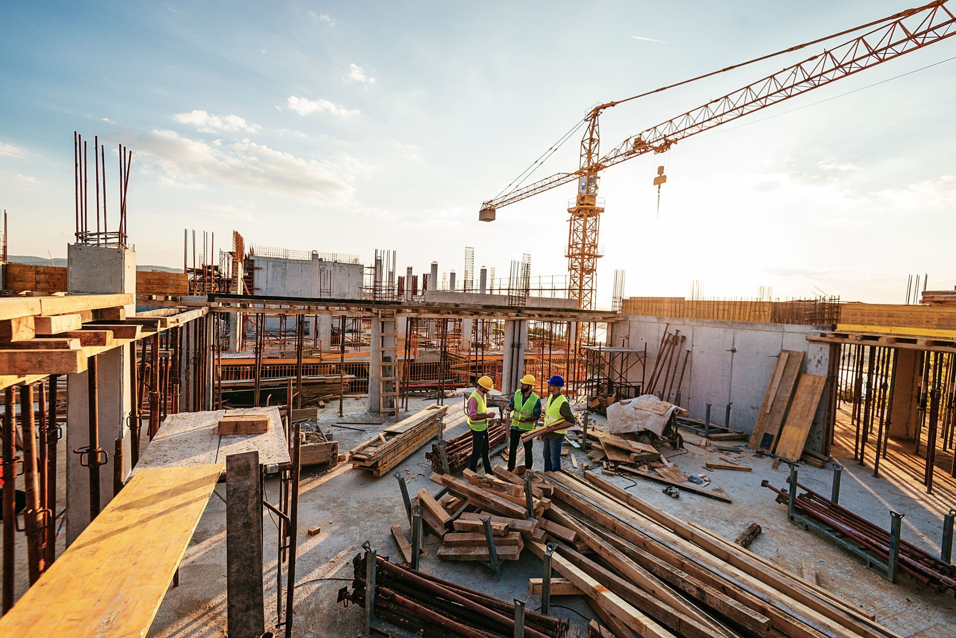 A group of construction workers are working on a building under construction.