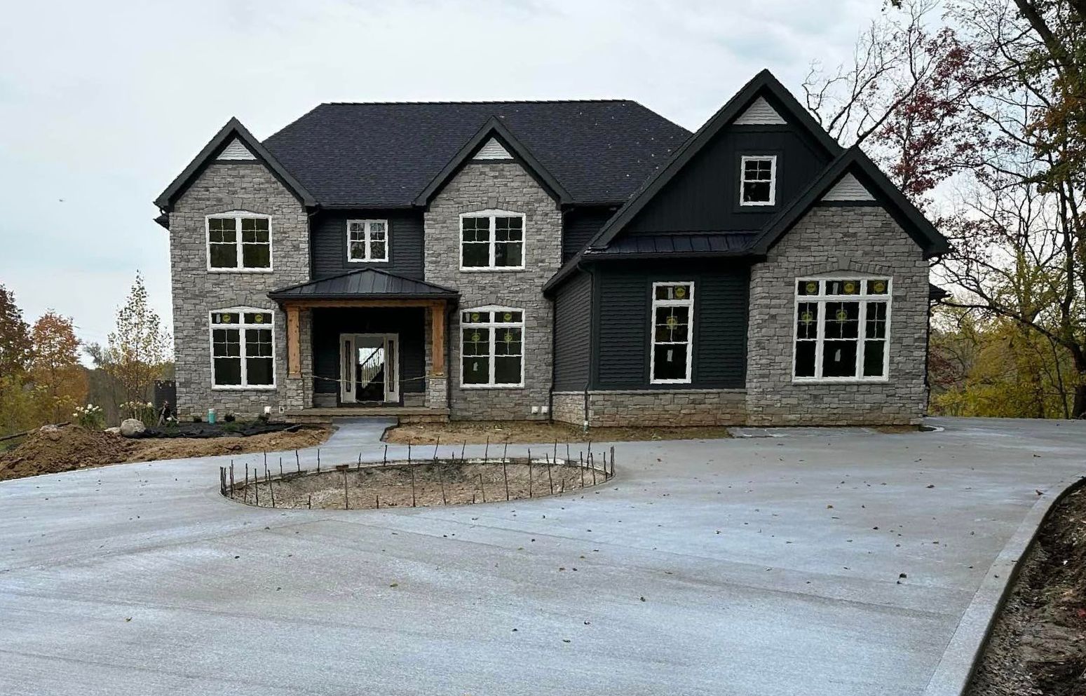 A large house with a concrete driveway in front of it.