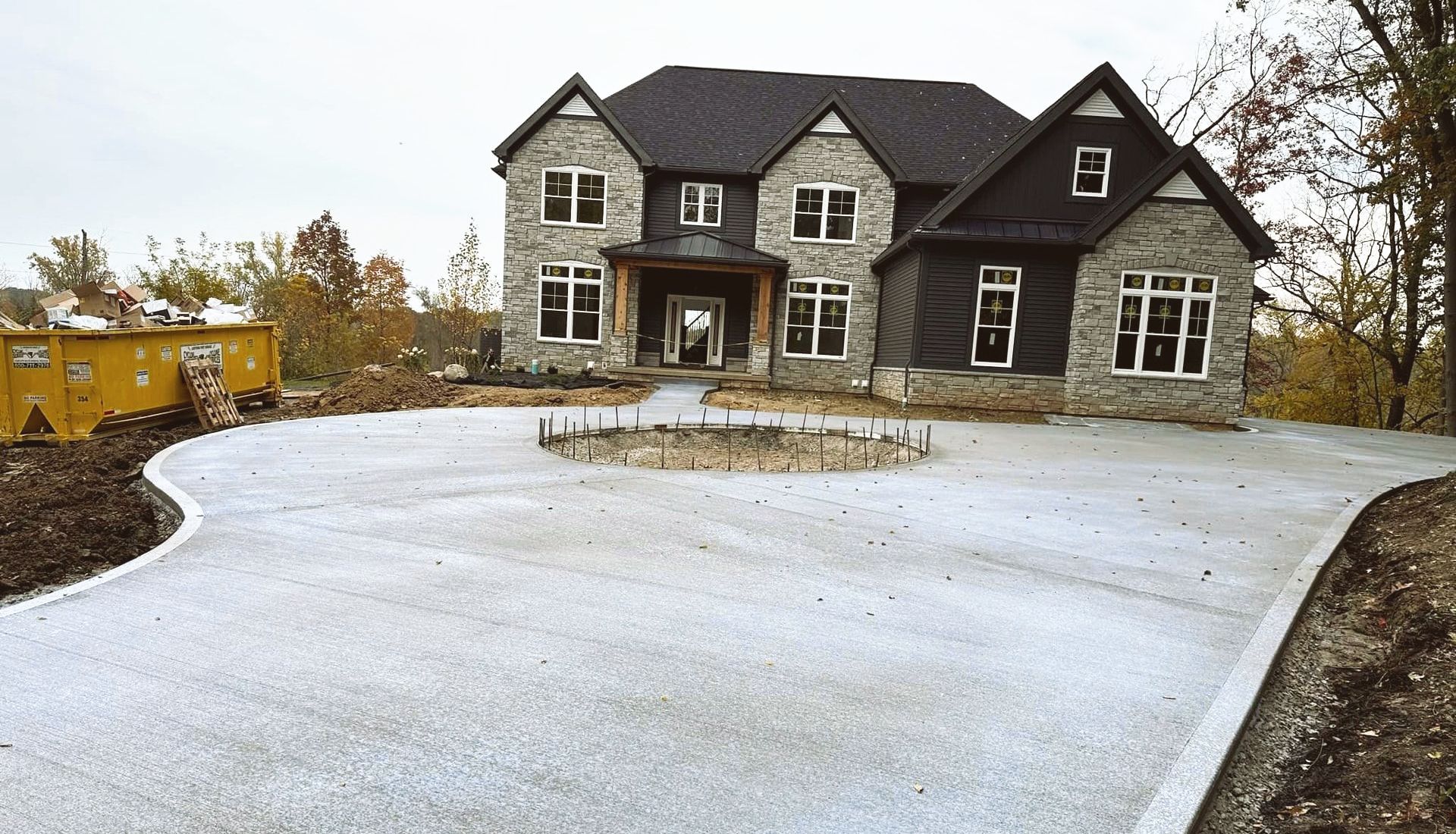 A large house with a concrete driveway in front of it.