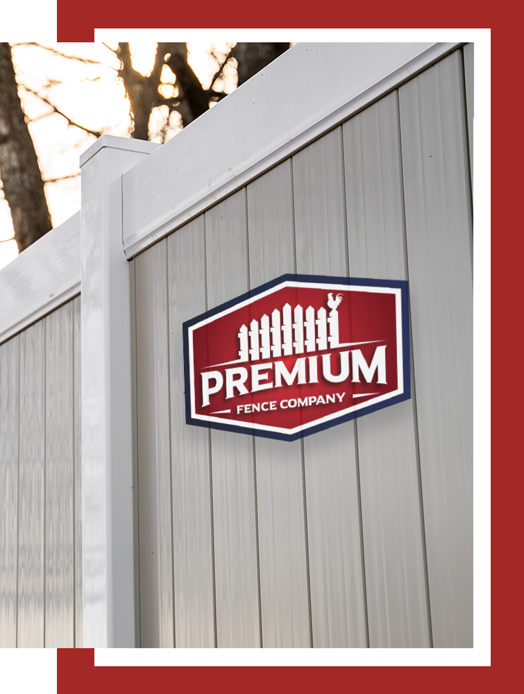 A white fence with a red sign that says premium fence company