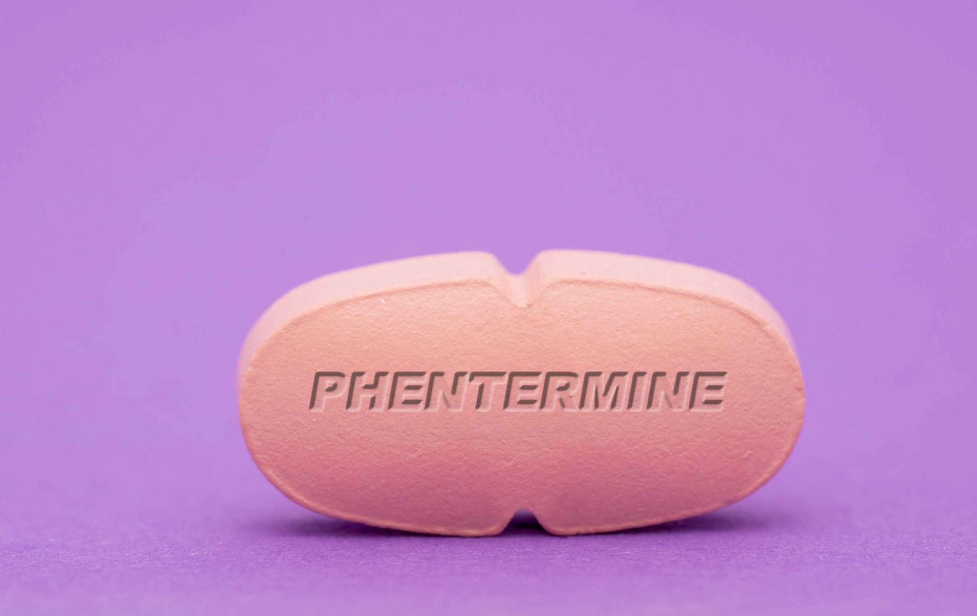 Pink, oblong pill with 