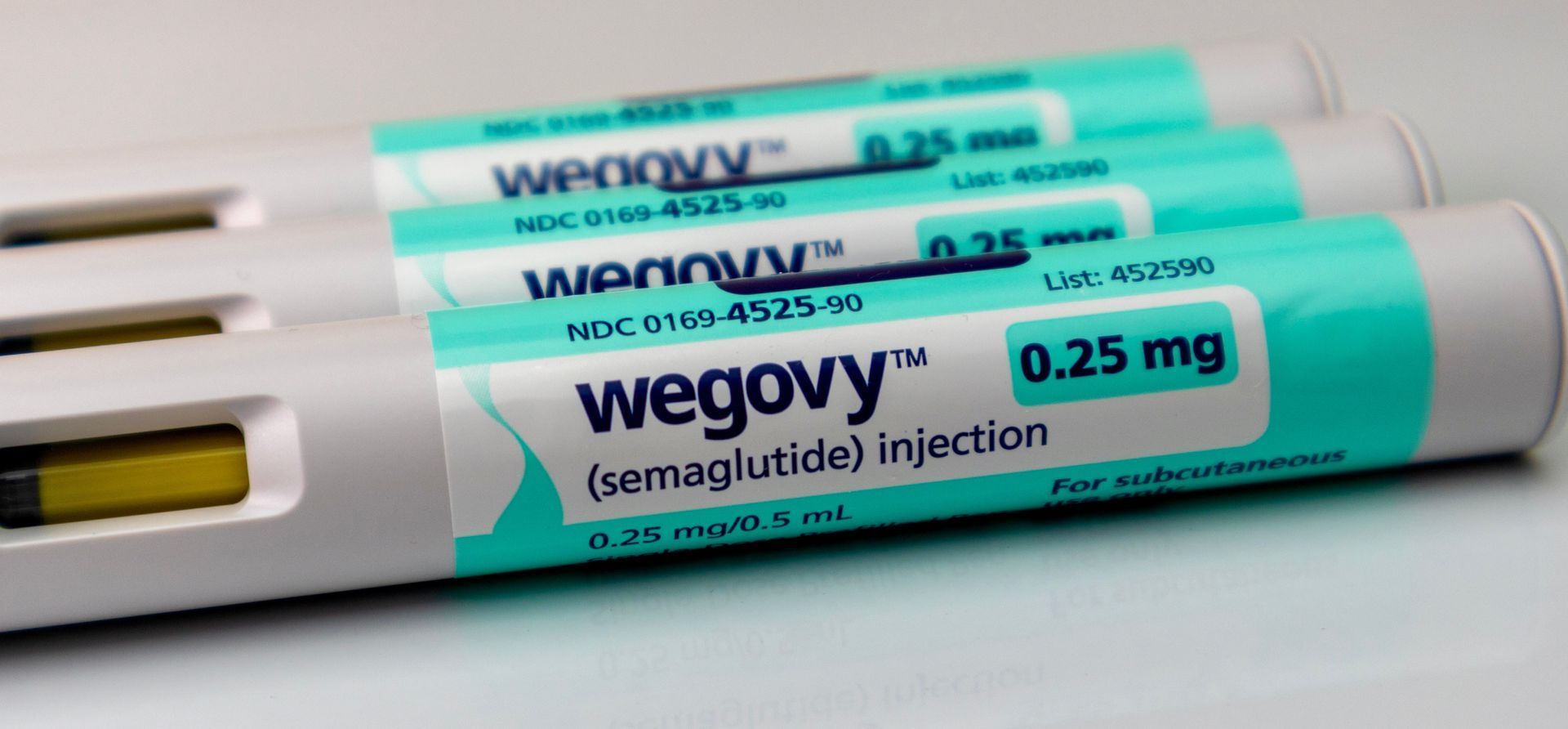 Three Wegovy (semaglutide) injection pens, 0.25 mg dosage. White and teal with black text.