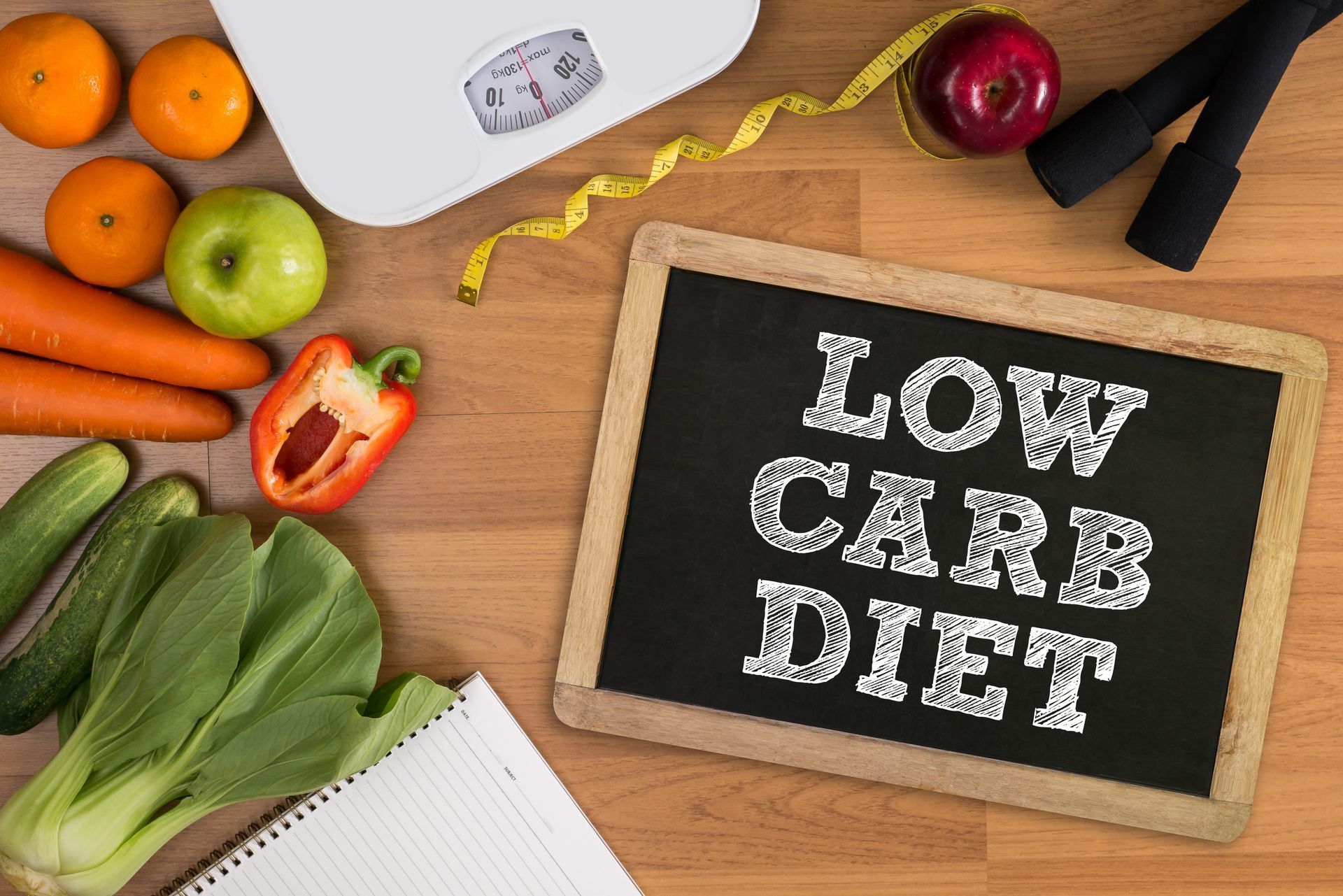 Healthy food and exercise equipment with chalkboard reading 
