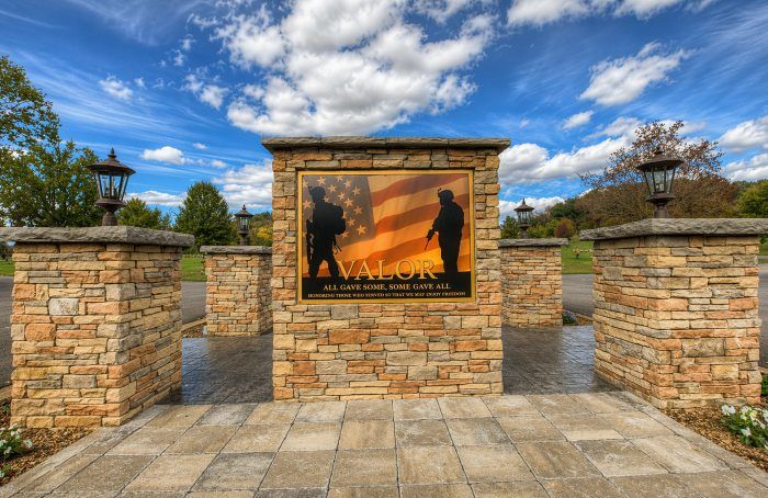 Stone Valor memorial at Brentwood, TN Veterans Services with patriotic tribute panel and lantern posts