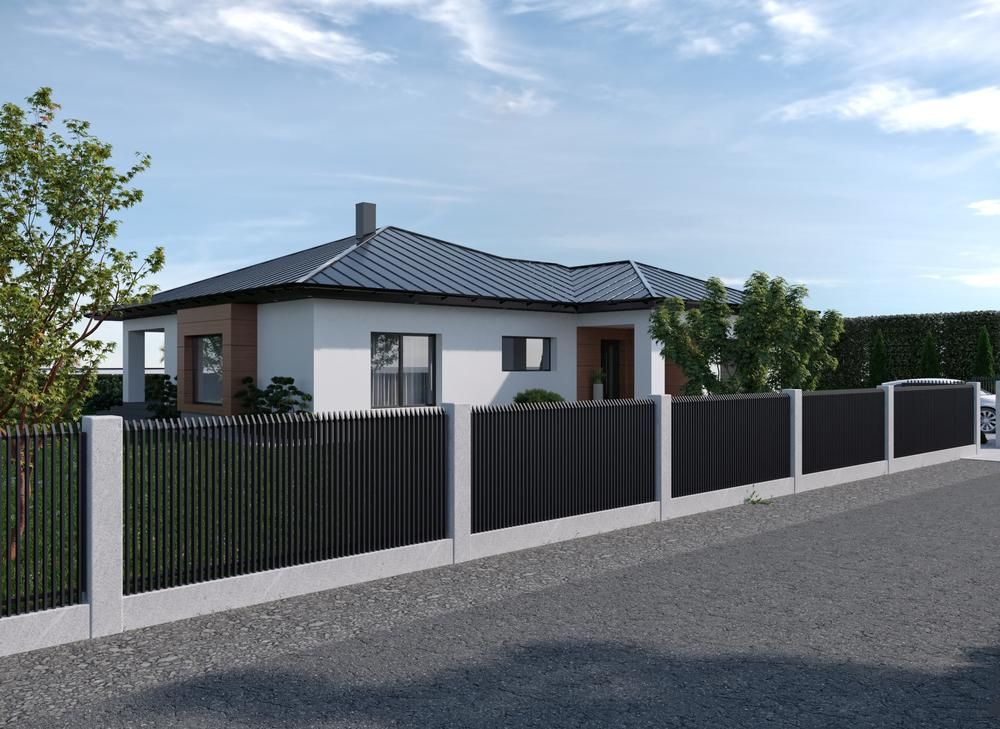 A White House With A Black Fence Around It — Rabbo's Fencing Services In Palmerston, NT