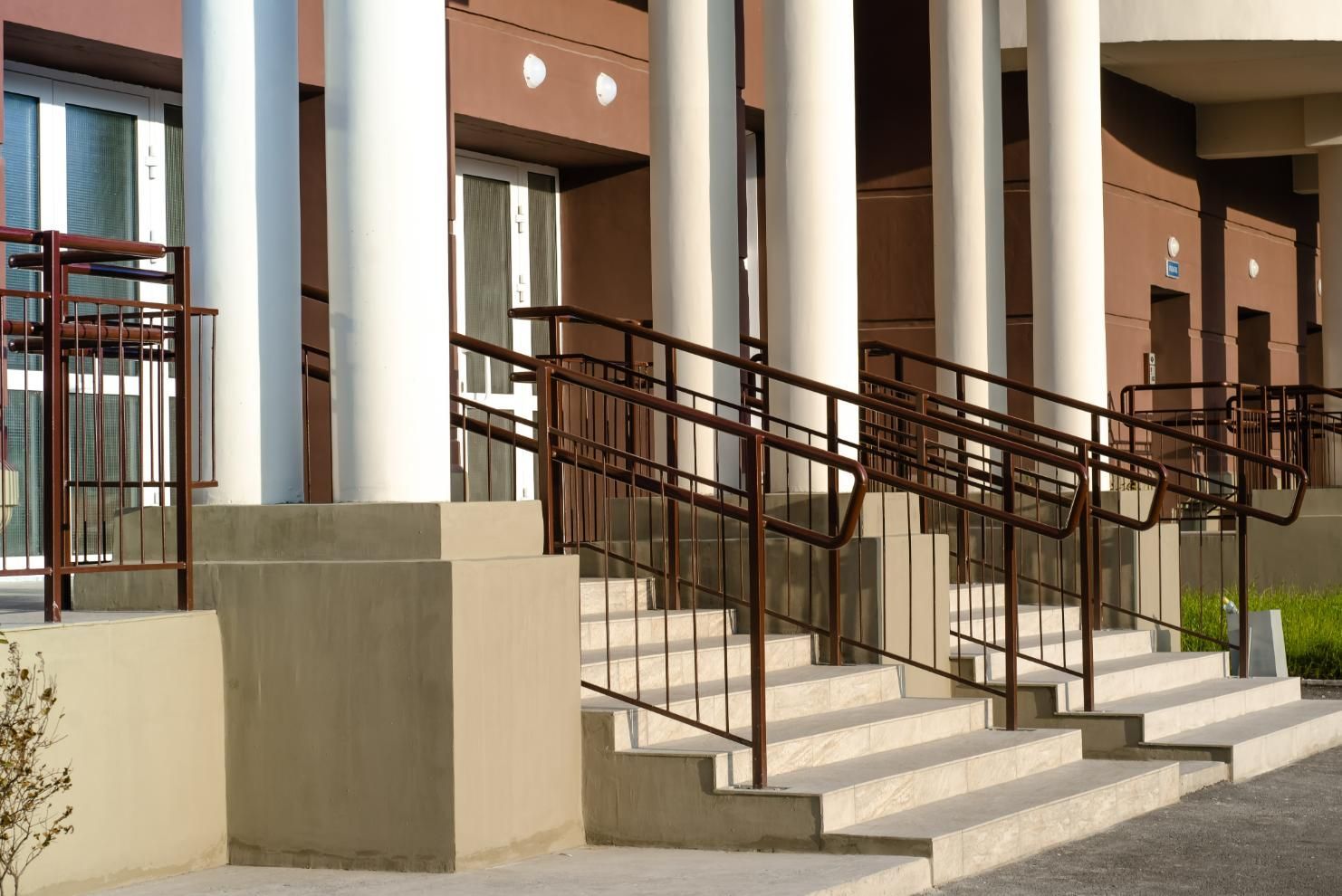 A Row Of Columns And Stairs Leading Up To A Building — Rabbo's Fencing Services In Noonamah, NT