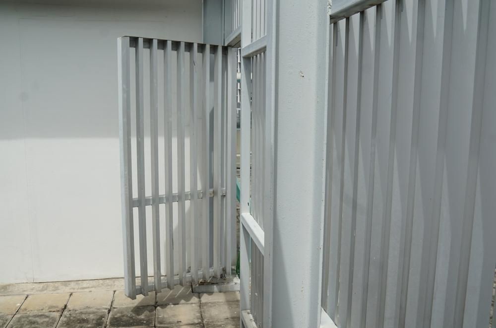 A White Fence With A Gate That Is Open — Rabbo's Fencing Services In Howard Springs, NT