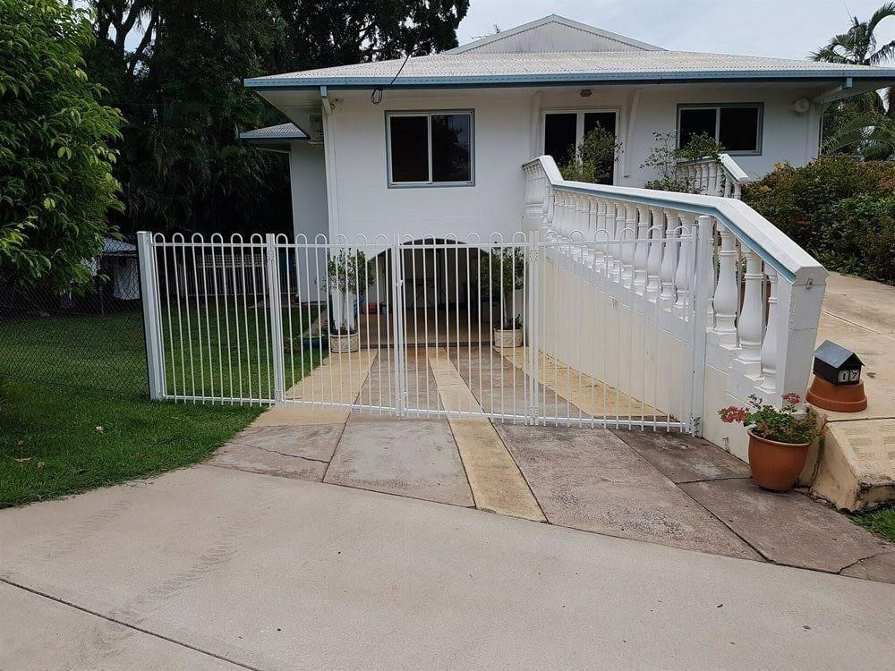 A White House With A White Fence And Stairs — Rabbo's Fencing Services In Pinelands, NT