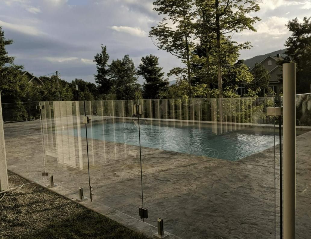 A Glass Pool Fence Around A Pool in A Darwin Backyard — Rabbo's Fencing Services In Pinelands, NT