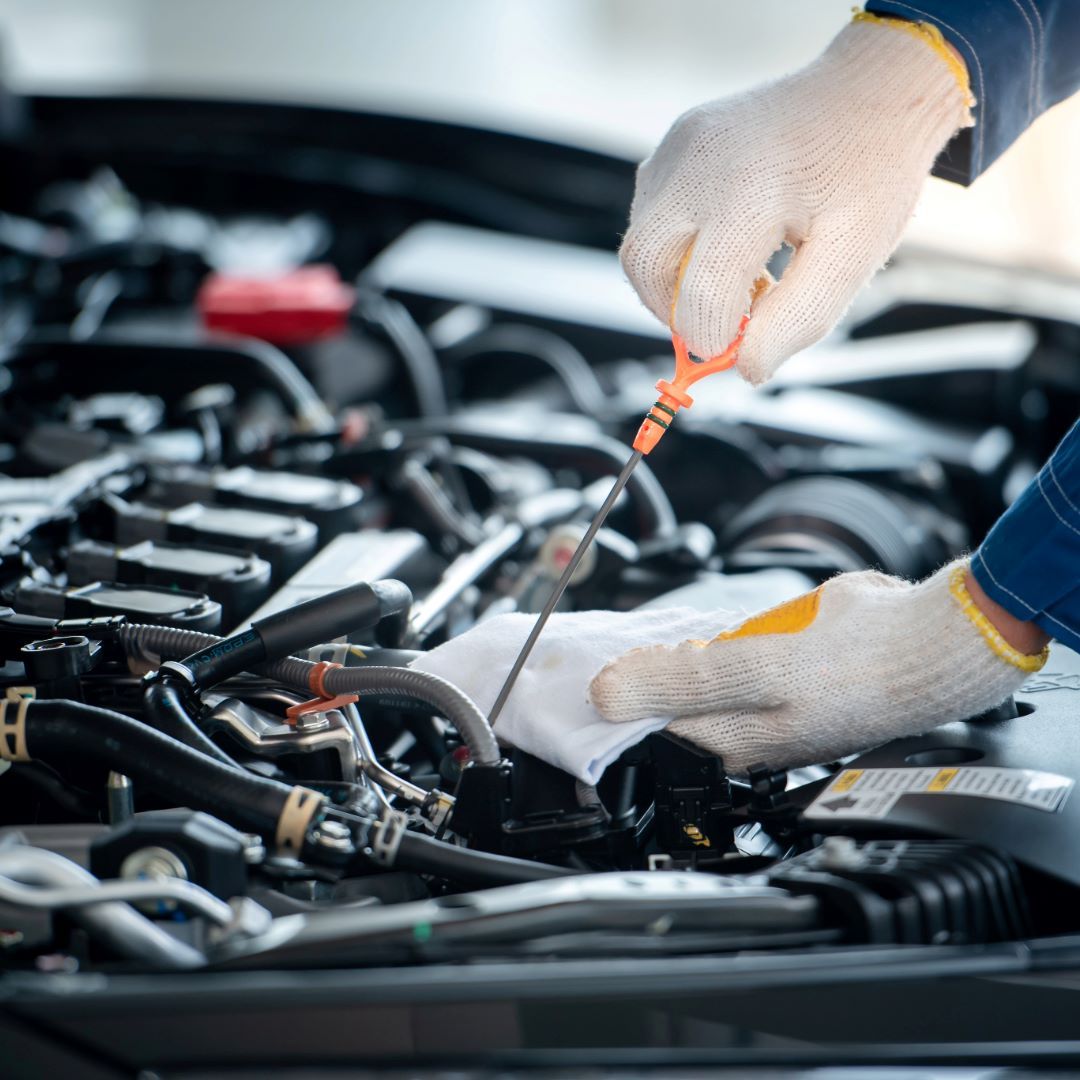 Mechanic checking engine fluids during routine maintenance at ABC Auto Repair in Burien, WA