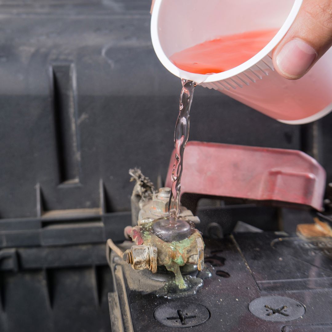Mechanic inspecting a car battery at ABC Auto Repair in Burien