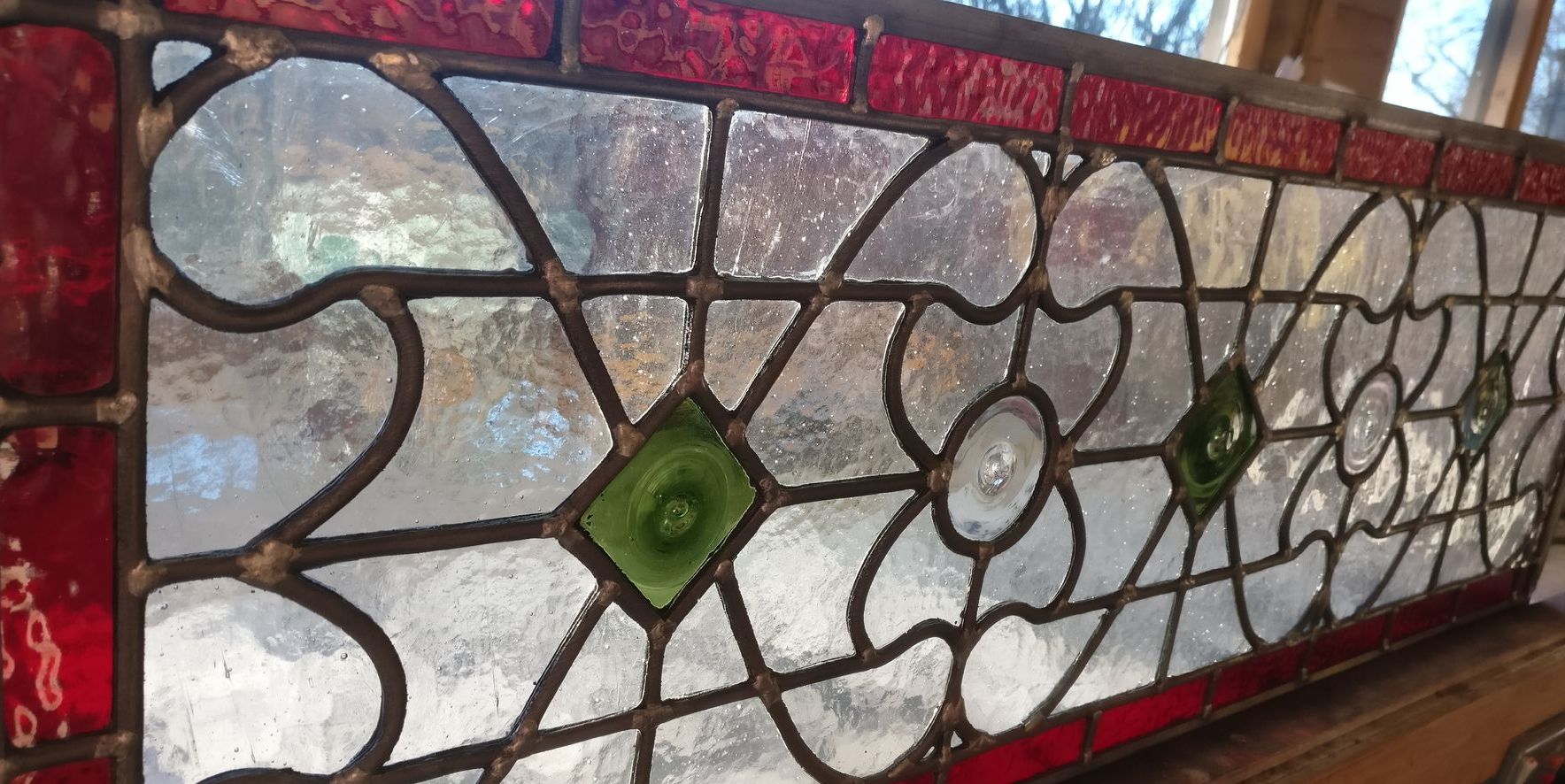 Stained glass has a history which goes back thousands of years and stained glass windows in Britain can be dated back to the 7th century.  Glass as a material, appears to have first been used in windows by the Romans and later, the Anglo Saxons developed the Medieval art form where coloured glass and lead were combined to create decorative windows in churches and cathedrals.