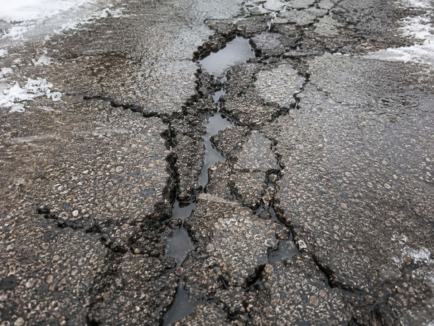 freeze thaw damage causing asphalt cracks