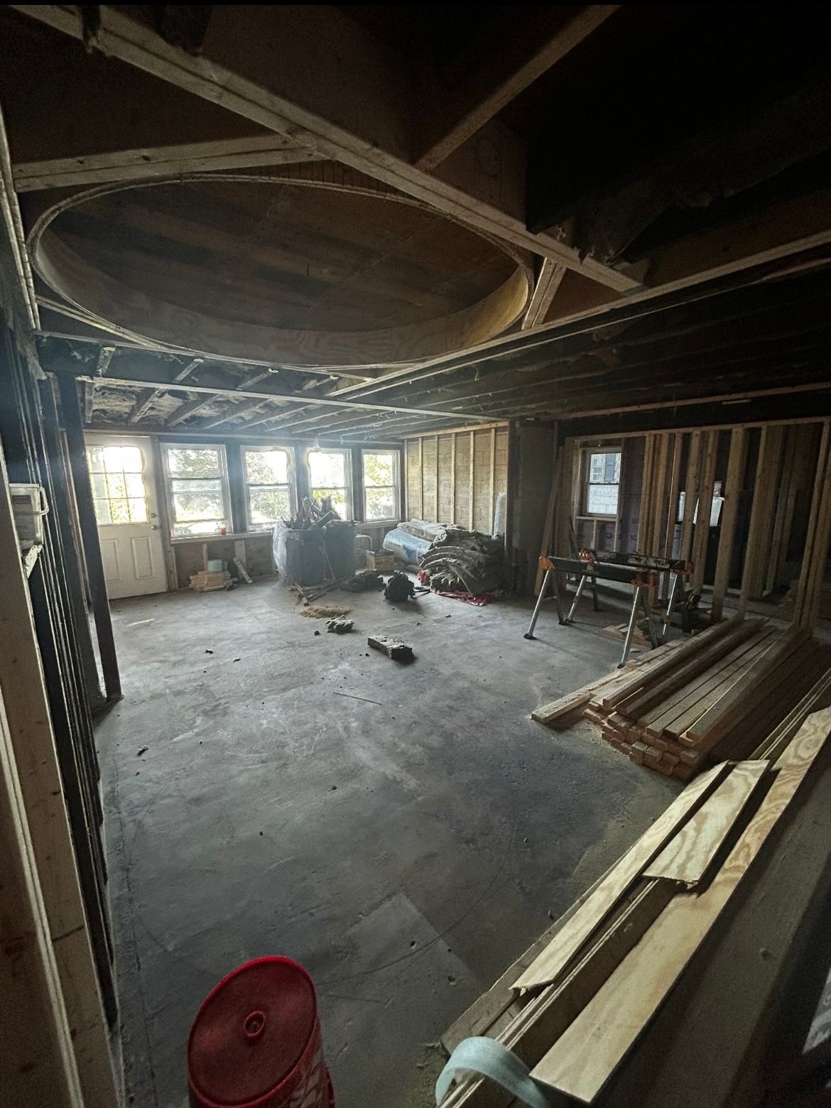 A large room with a lot of wood in it is being remodeled.