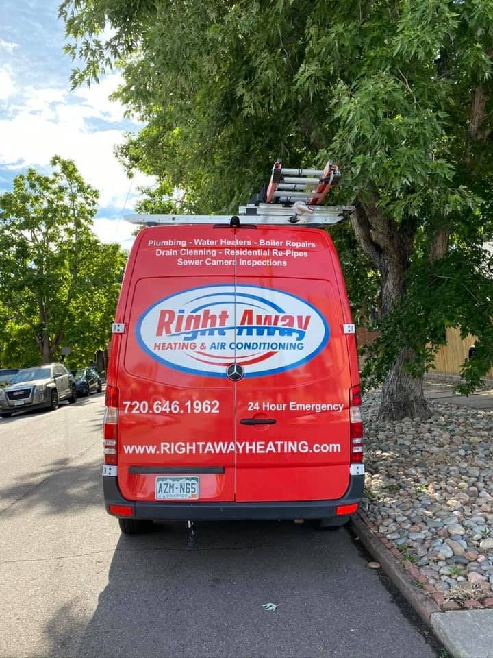 Red Right Away Heating & Air Conditioning van parked on the street with ladder on top.
