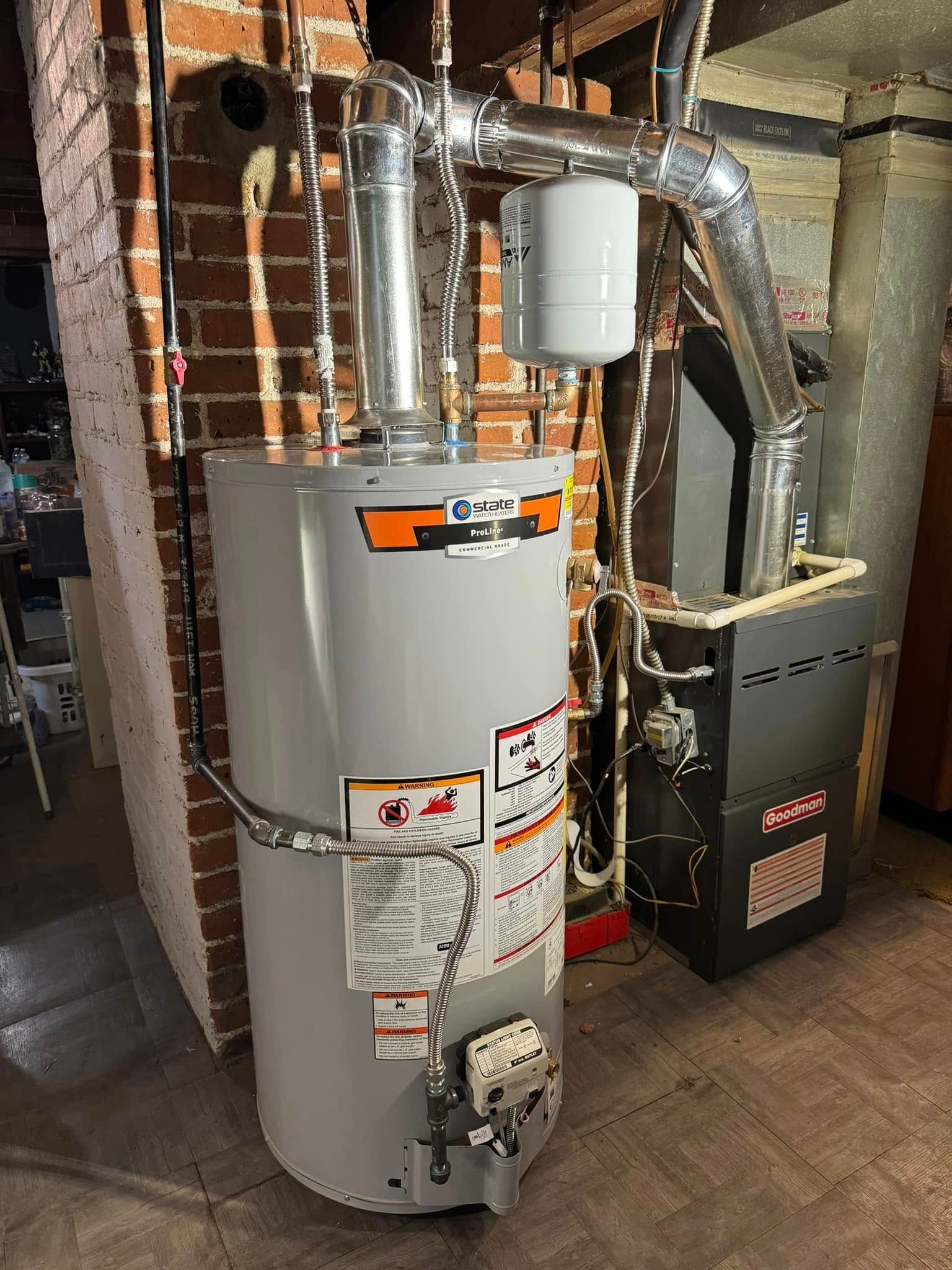 A natural gas water heater and furnace in a basement setting. Pipes and ductwork are visible.
