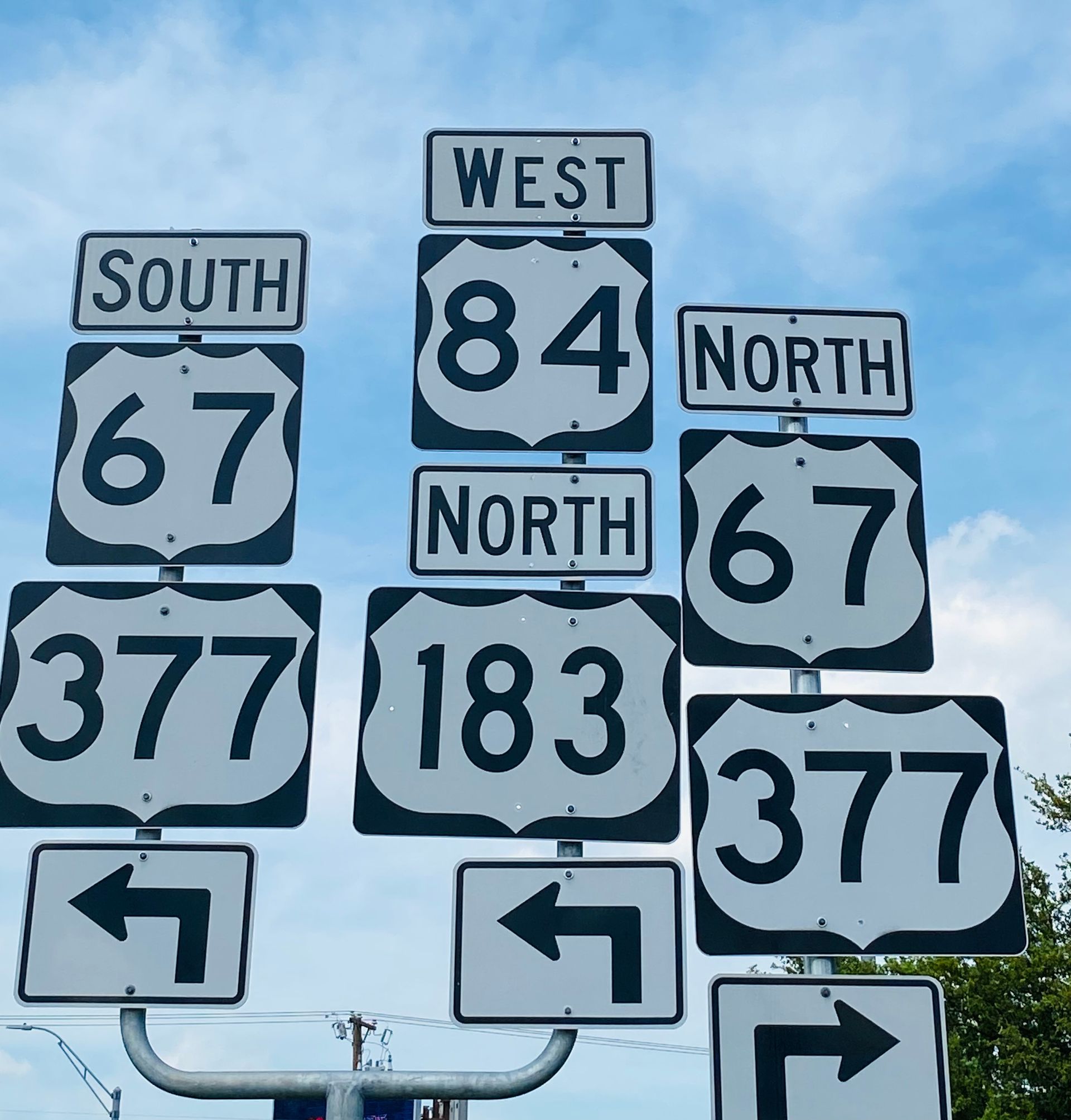 Highway signs for TX 377, 183, 67, and 84 in Brownwood, TX, showing the city’s central location