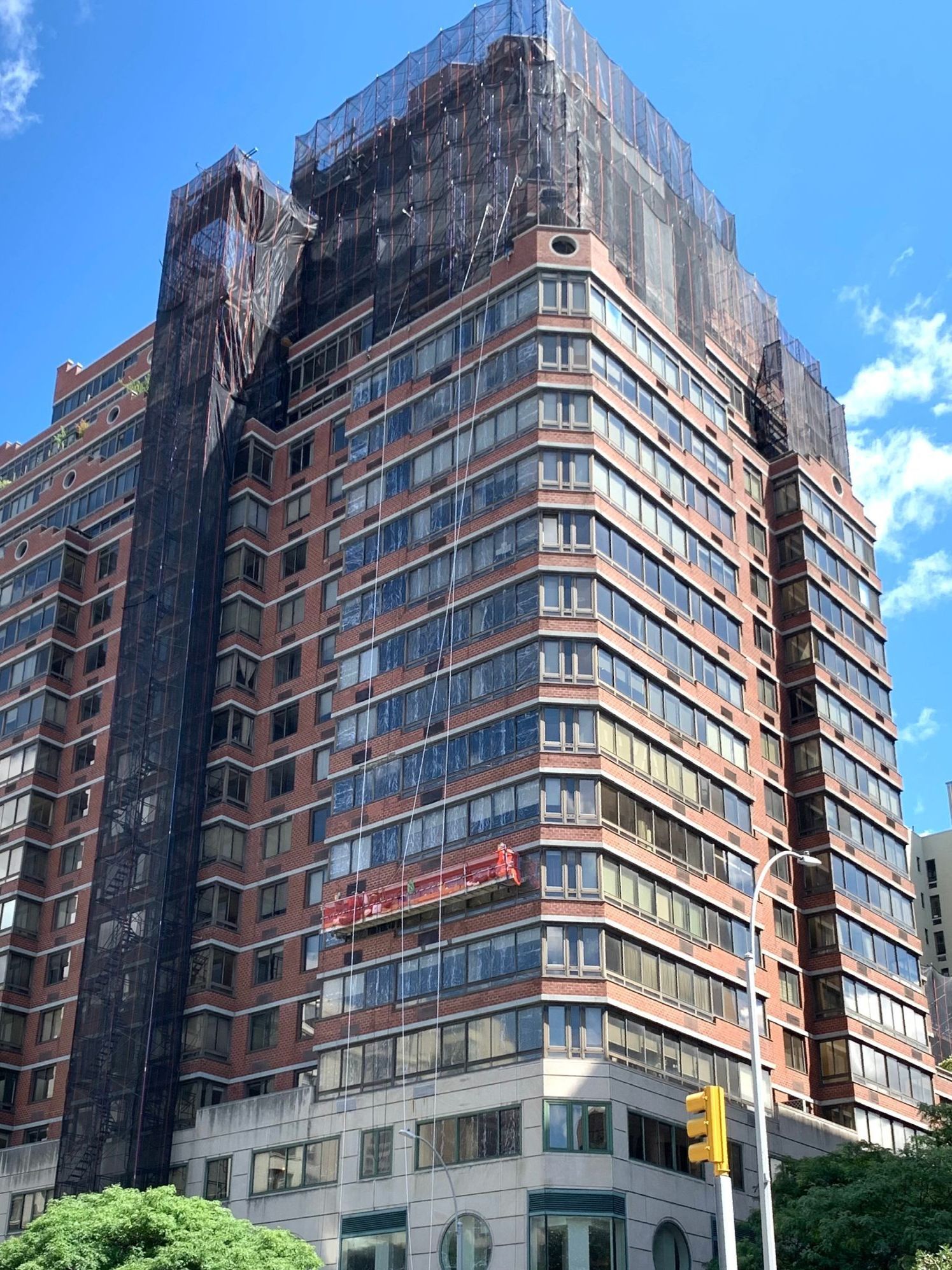 A tall building with a lot of windows is under construction.