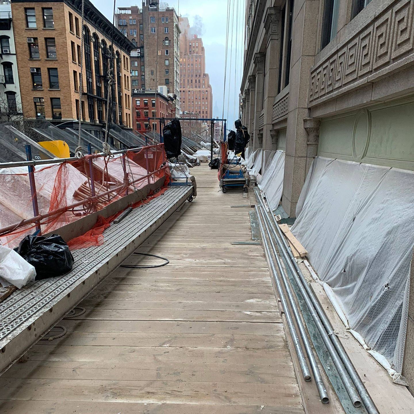 A construction site with a lot of scaffolding and pipes