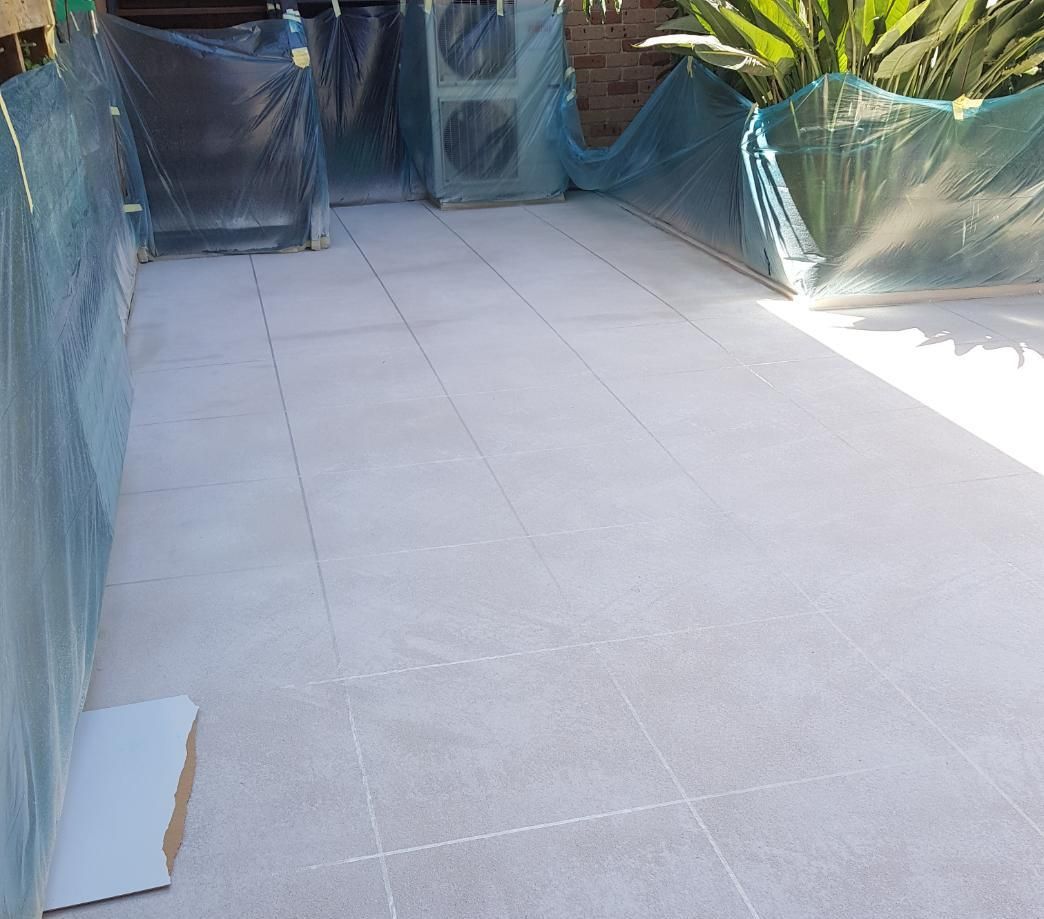 A White Tiled Floor Is Covered In Plastic — Turn It Crete in St Georges Basin, NSW