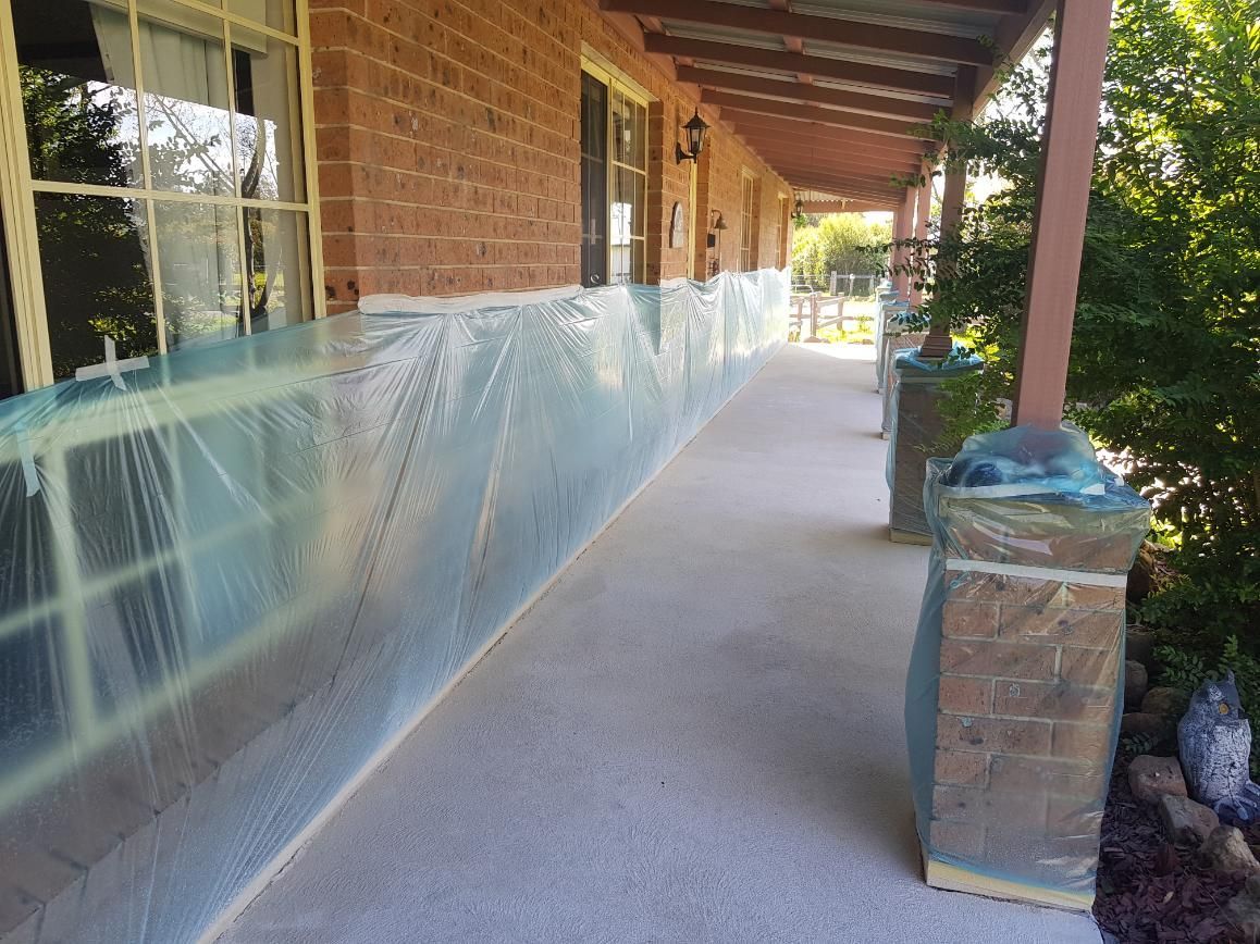 A Brick House With A Porch Covered In Plastic Wrap — Turn It Crete in St Georges Basin, NSW