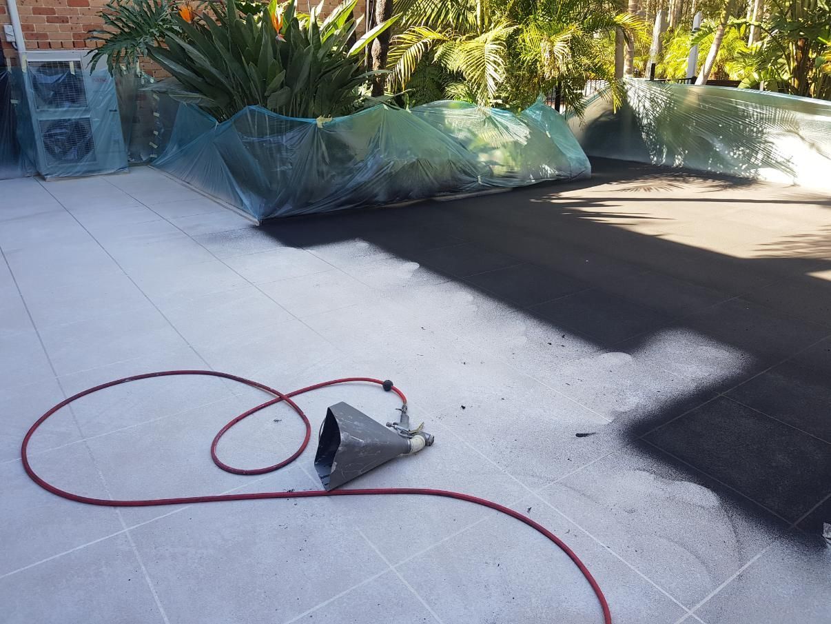 A Hose Is Laying On A Tiled Floor Next To A Sprayer — Turn It Crete in St Georges Basin, NSW