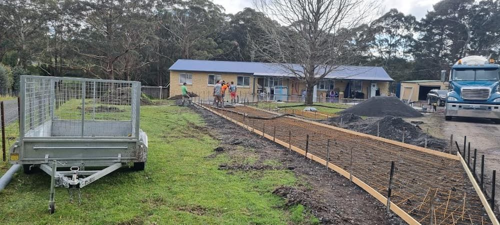 A Trailer Is Parked In Front Of A House — Turn It Crete in St Georges Basin, NSW