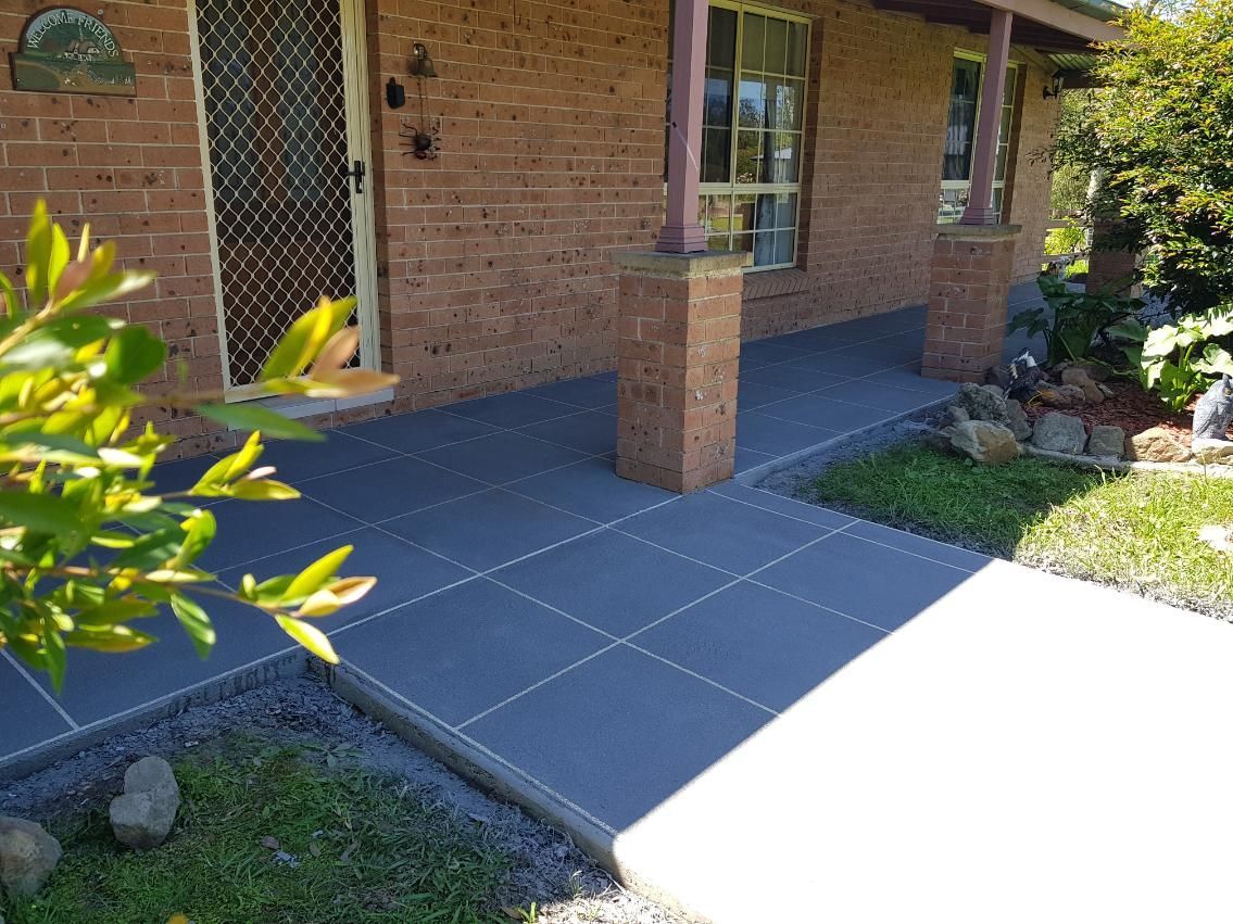 A Brick House With A Concrete Walkway In Front Of It — Turn It Crete in St Georges Basin, NSW
