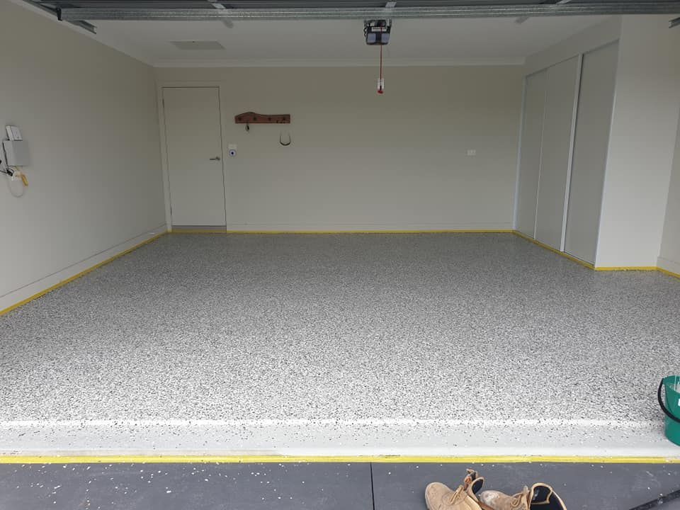 An Empty Garage With A Newly Laid Floor — Turn It Crete in St Georges Basin, NSW