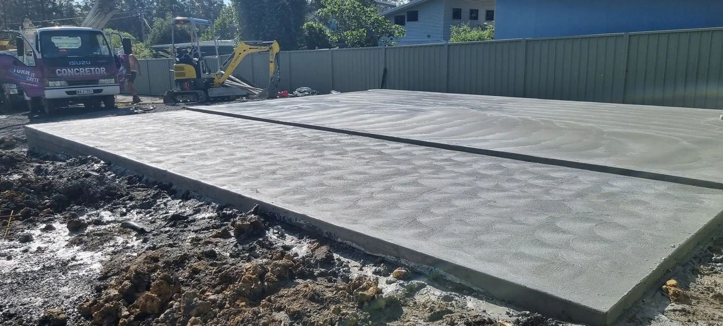 A Large Concrete Slab Is Sitting in The Middle of A Dirt Field — Turn It Crete in St Georges Basin, NSW