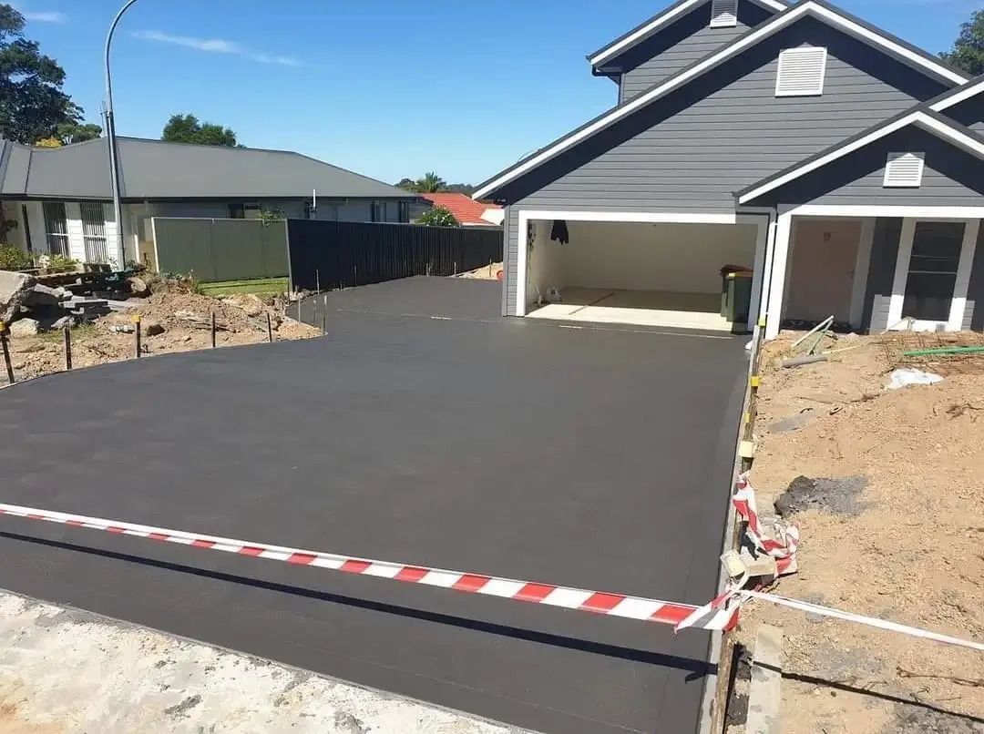 A Concrete Driveway Is Being Built in Front of A House — Turn It Crete in Vincentia, NSW