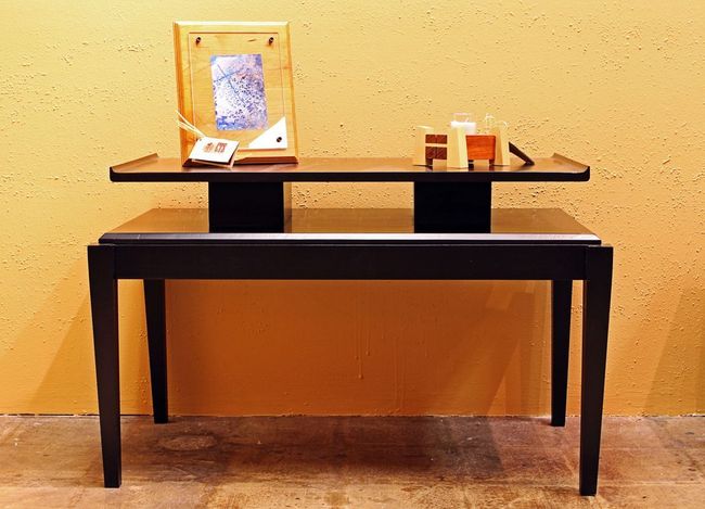 A table with a picture on top of it in a room.