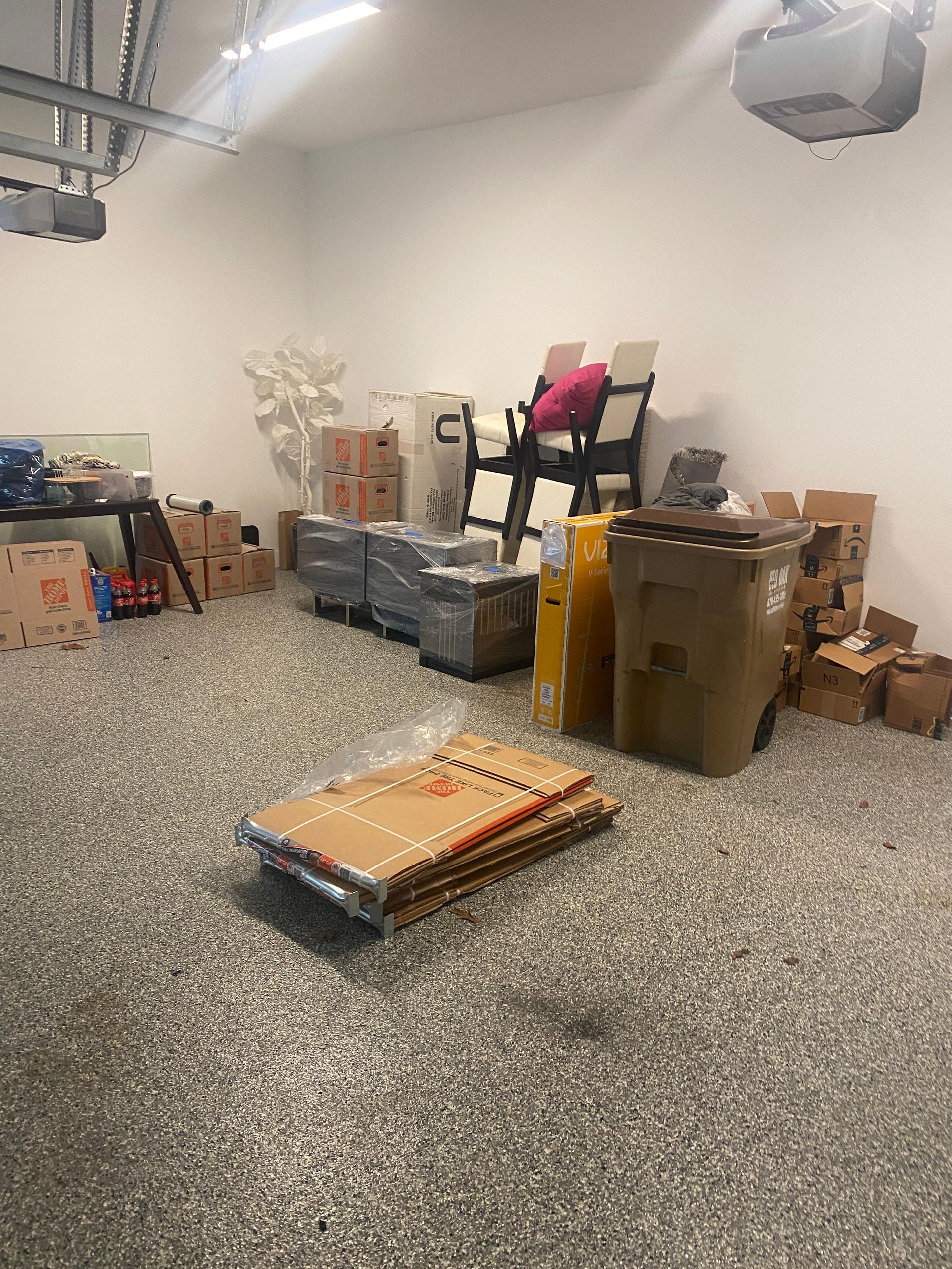 A garage filled with lots of boxes and chairs.