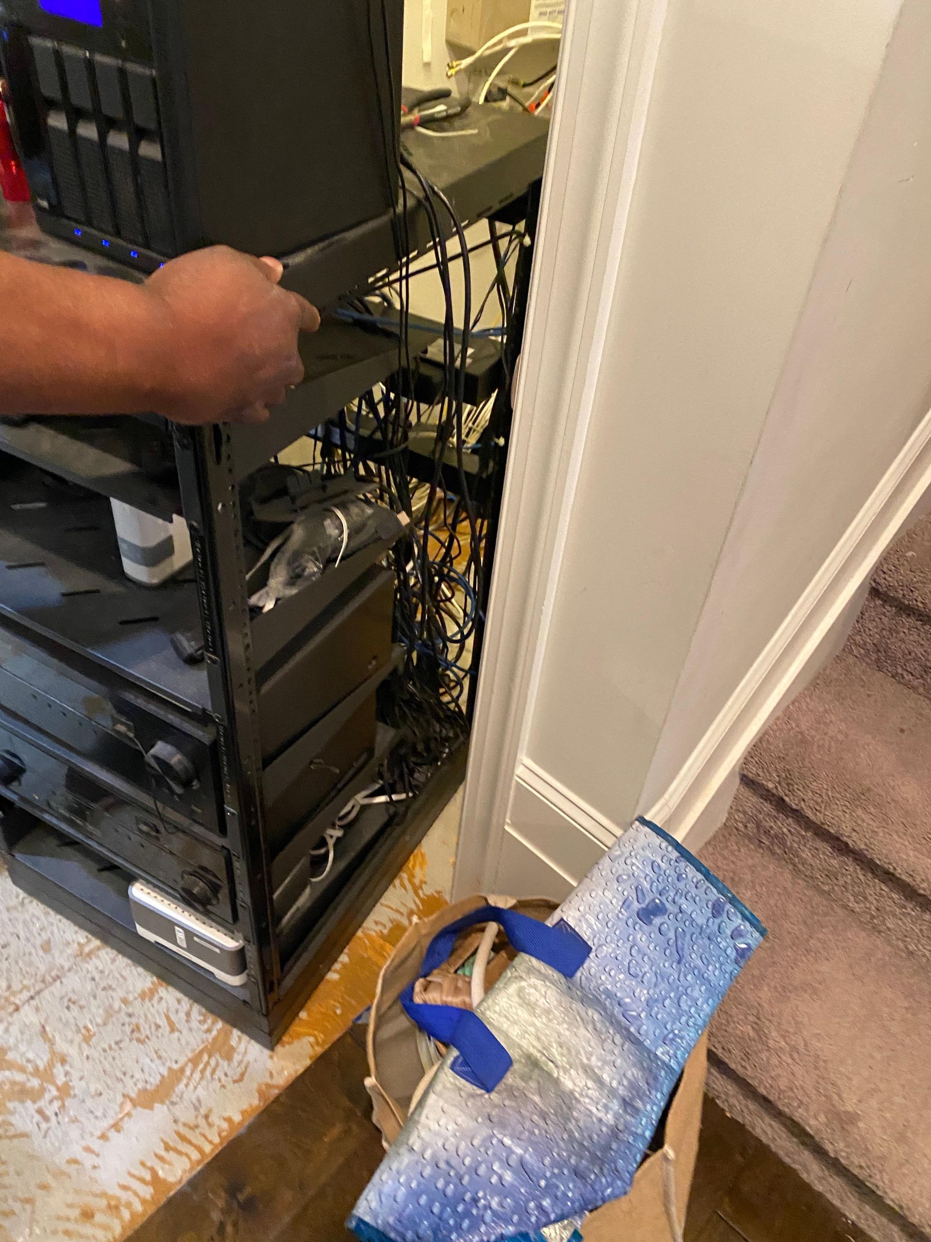 A man is working on a computer in a room.