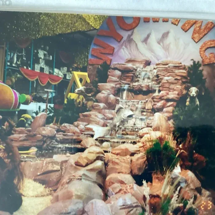 A decorative indoor display featuring a rocky waterfall set against a mountain backdrop with the word WYOMING above it.
