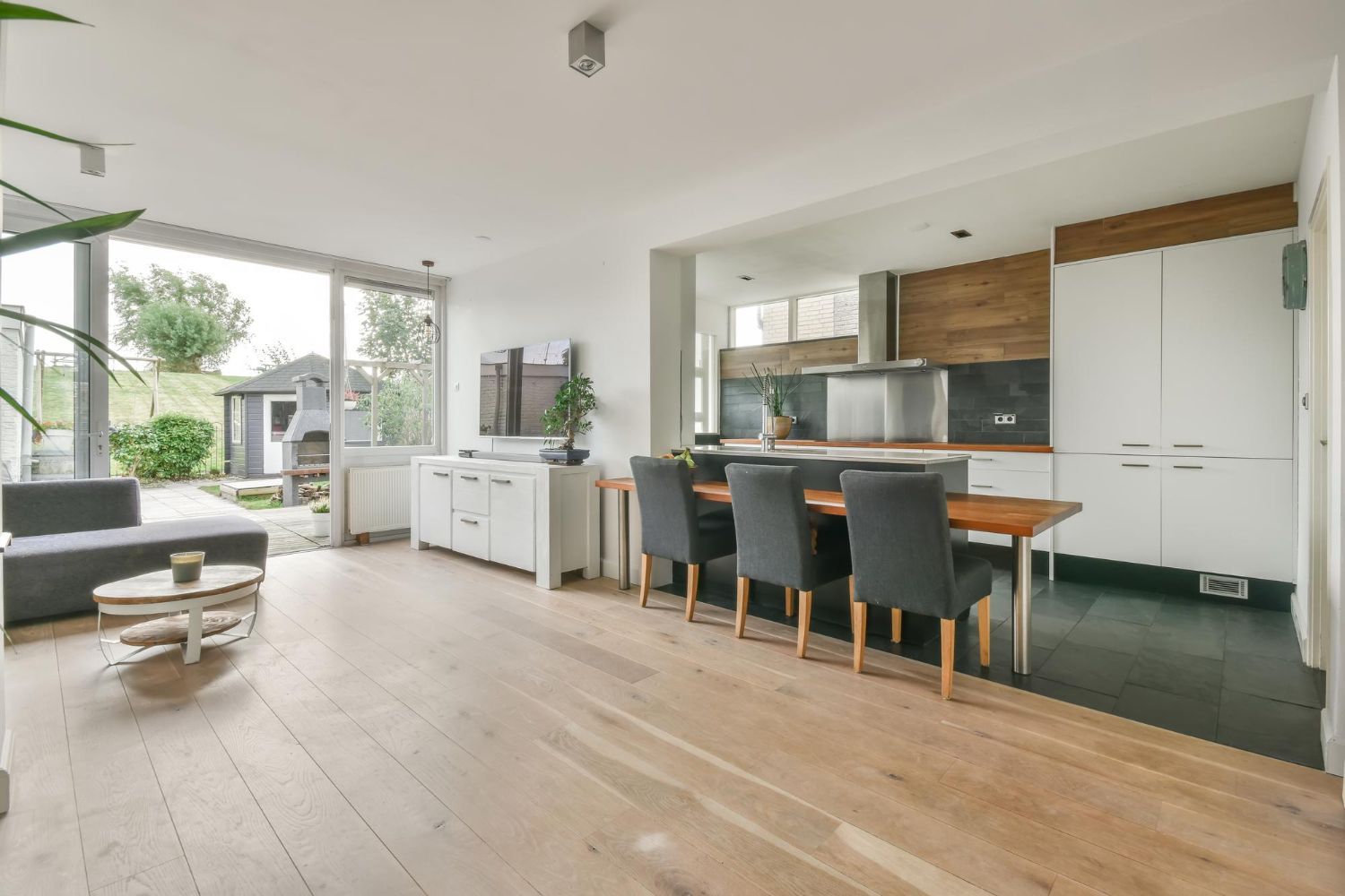 a living room with a table and chairs in it builders mid north coast